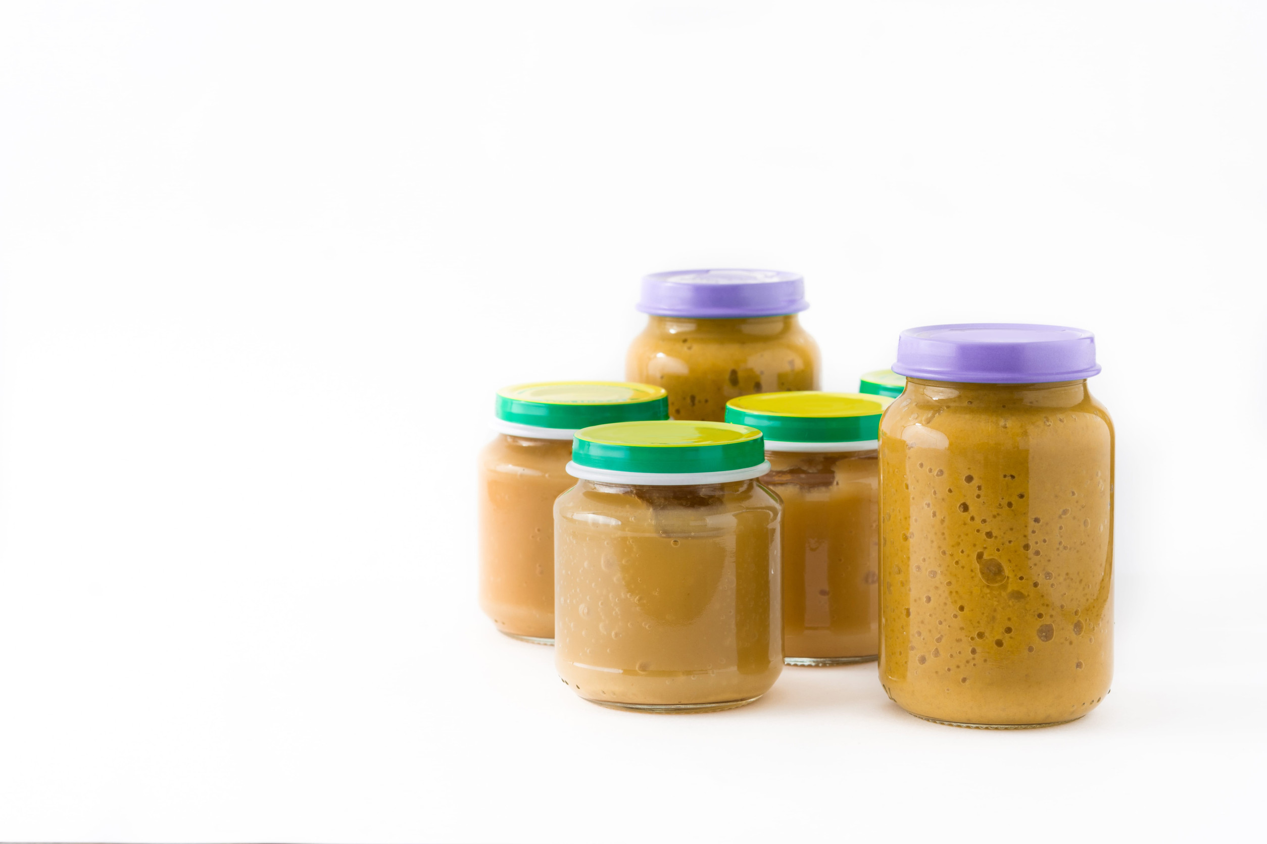 Baby food: Jar with fruit isolated on white background. Copyspace
