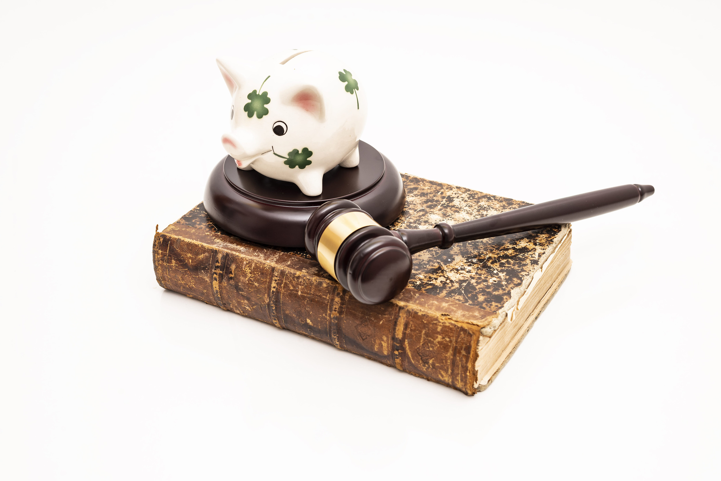 Piggy bank on judge's gavel. Savings concept with security.