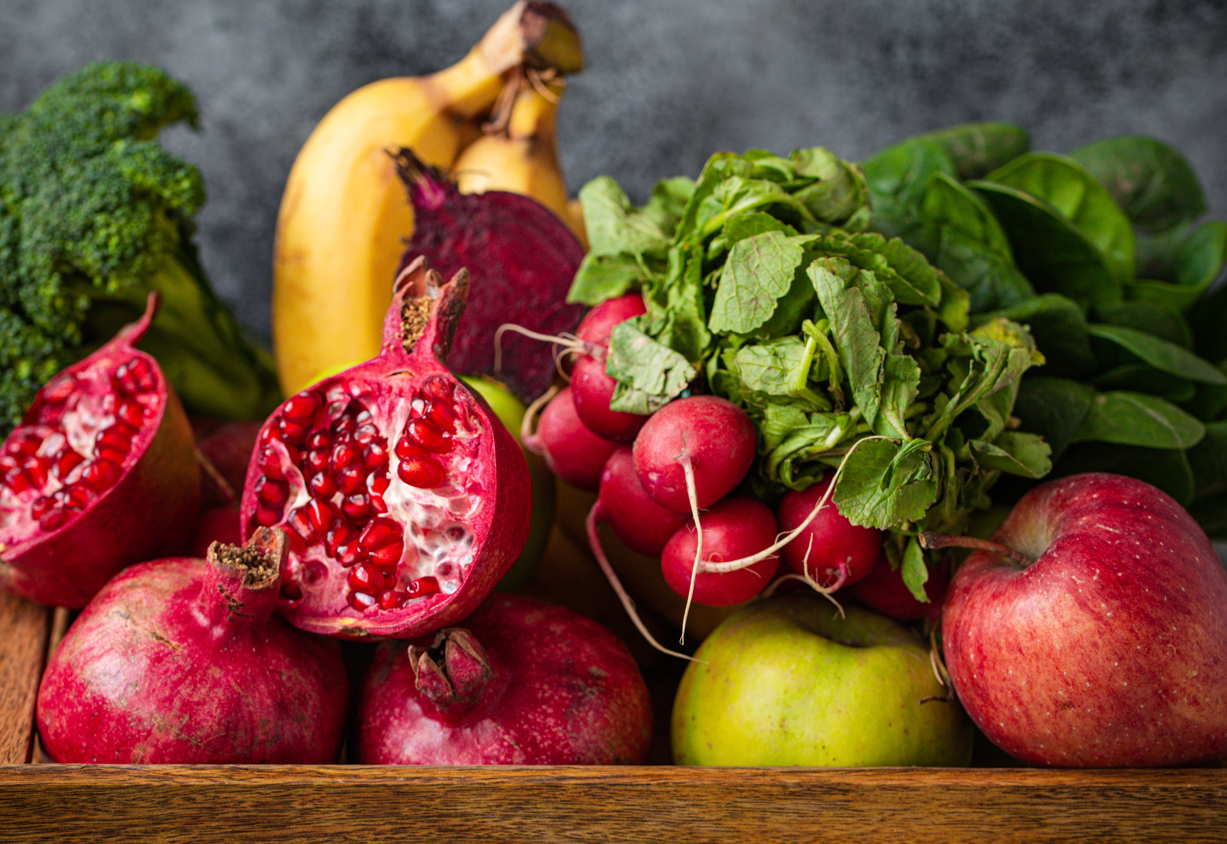Fresh fruit and vegetables in wooden tray