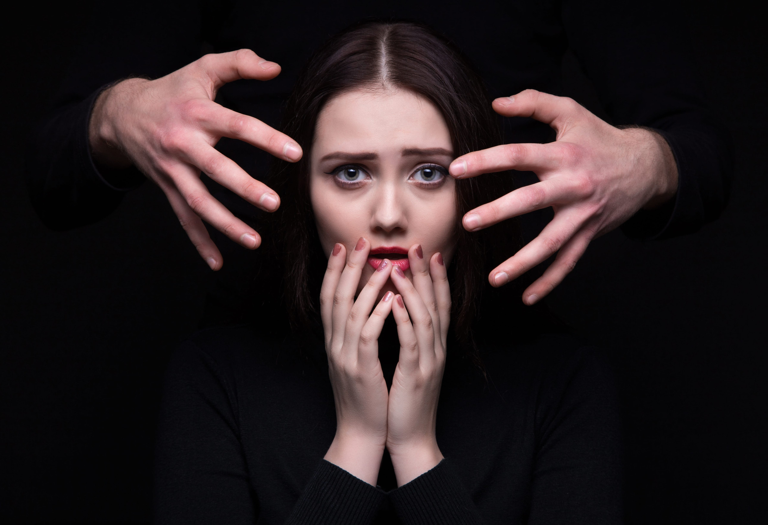 Scared brunette woman with hands