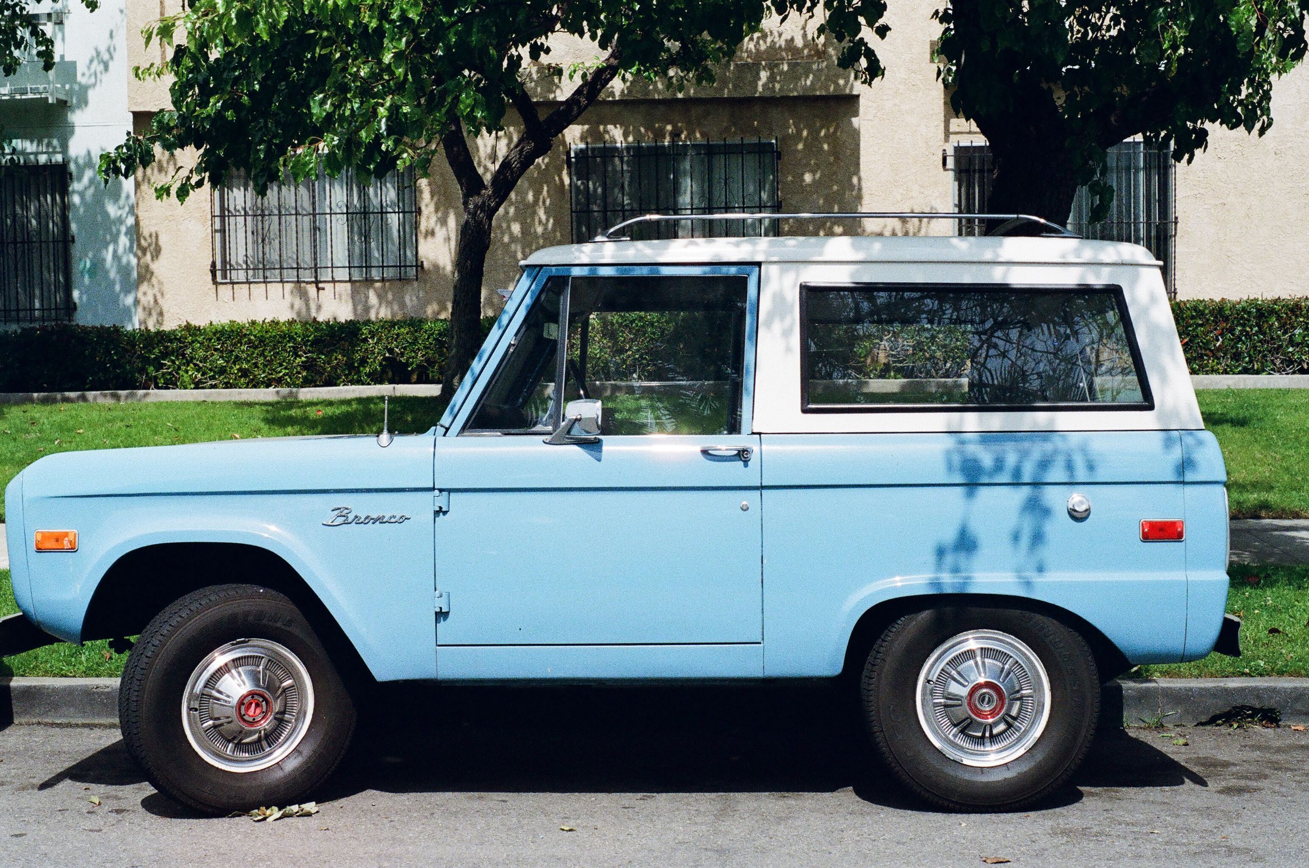 A classic blue Ford Bronco parked outdoors, showcasing vintage charm.