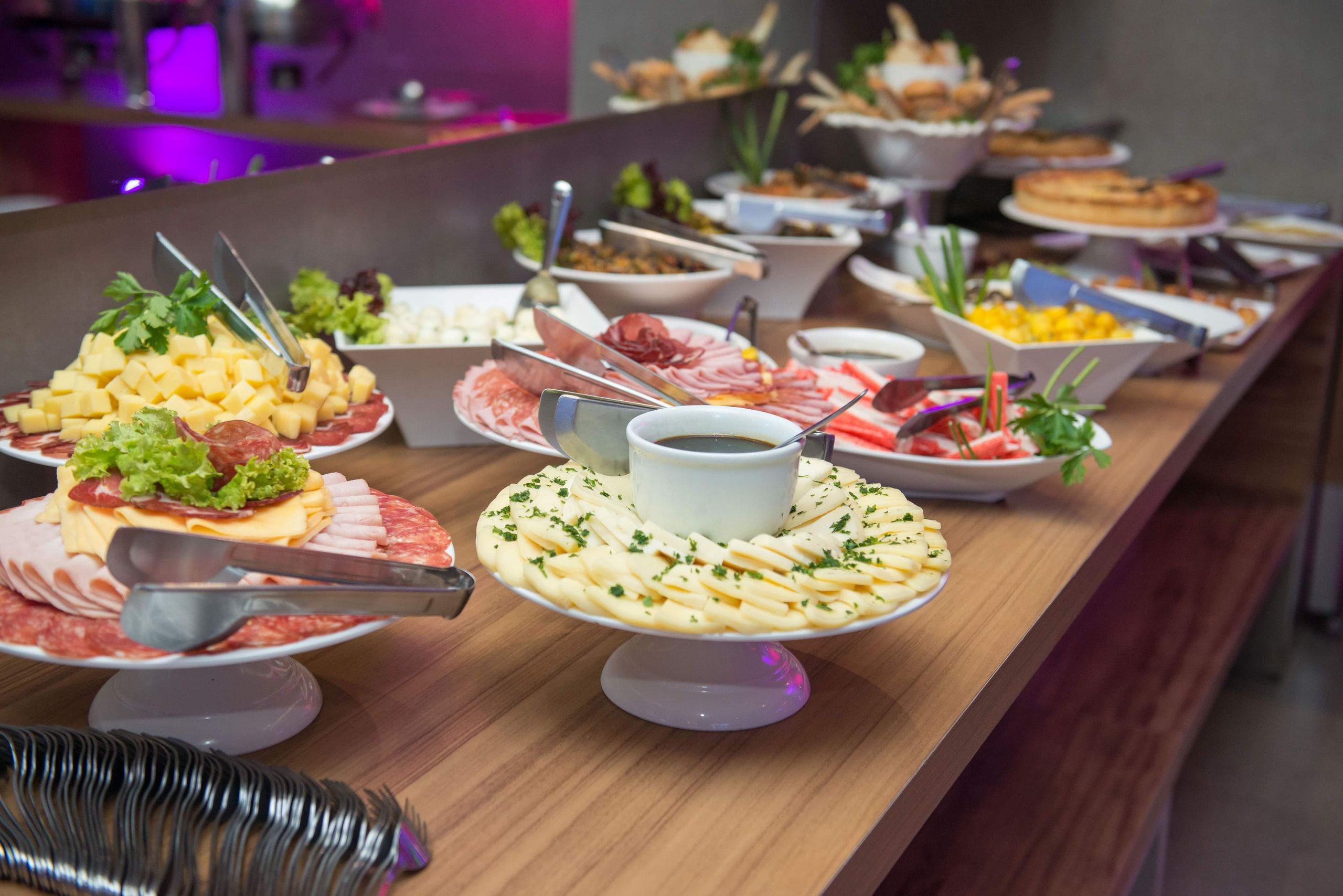 A delicious indoor buffet with assorted dishes on a wooden table.