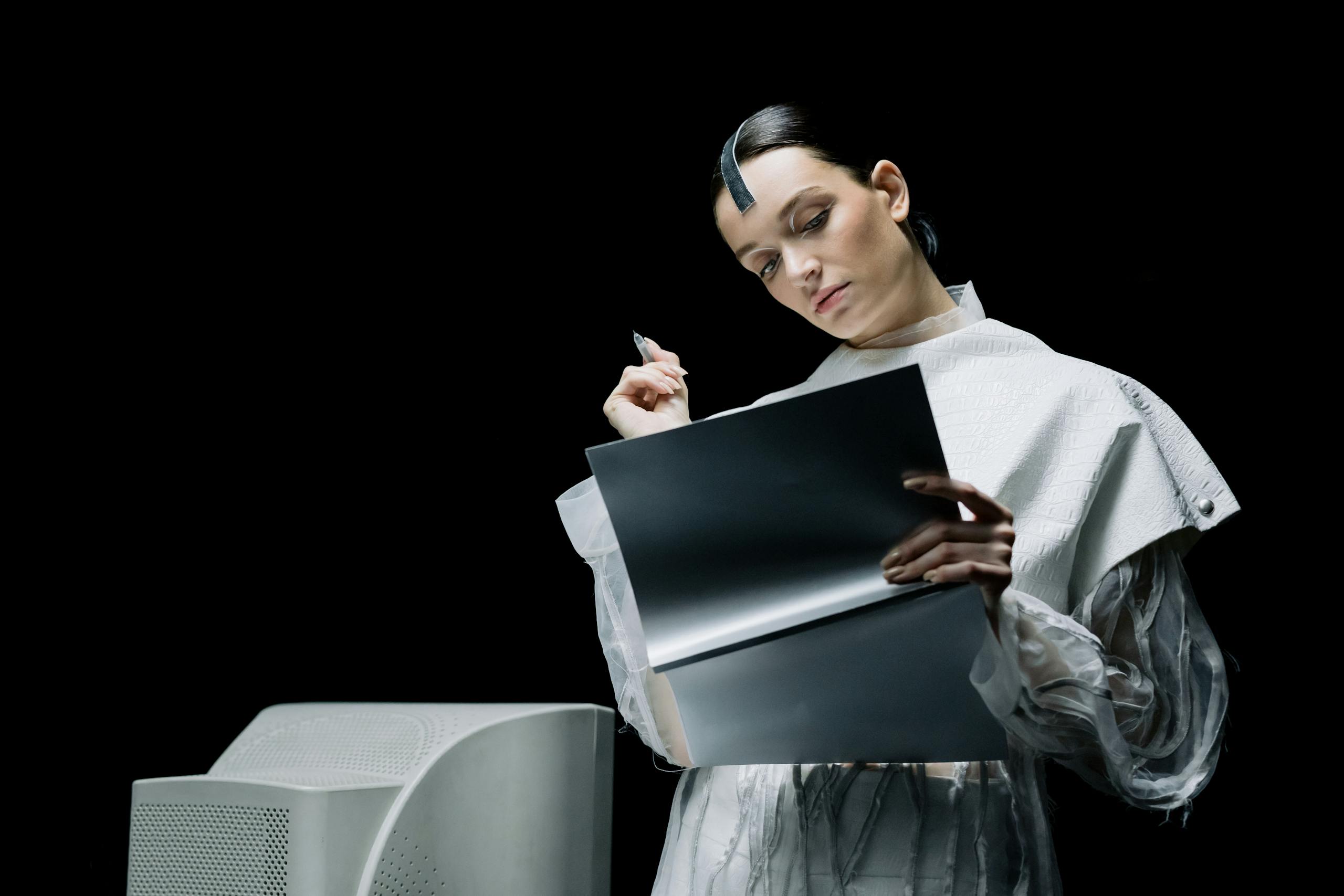 A female scientist with futuristic attire reviews notes in an advanced lab setting.