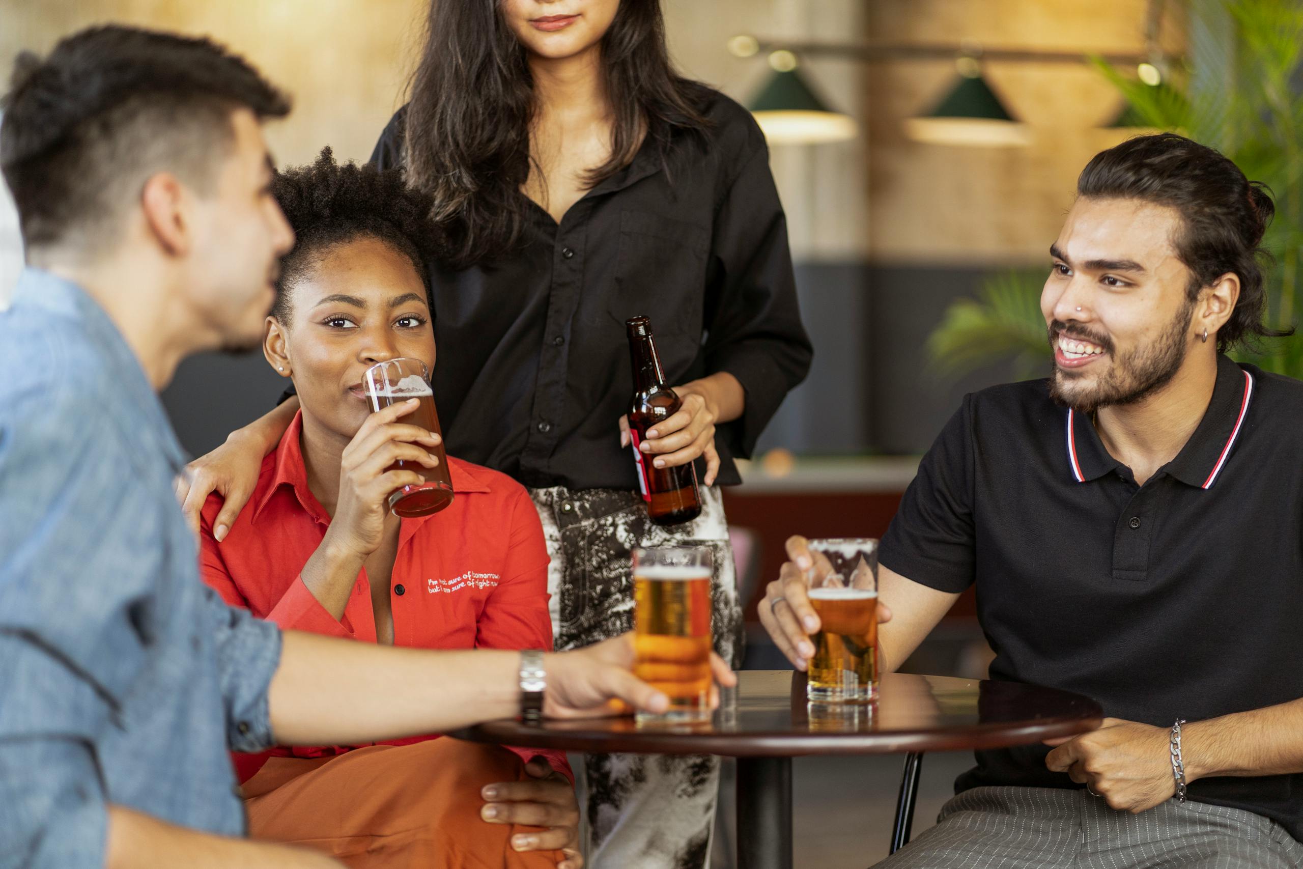 A group of friends enjoying drinks at a cozy indoor cafe setting.