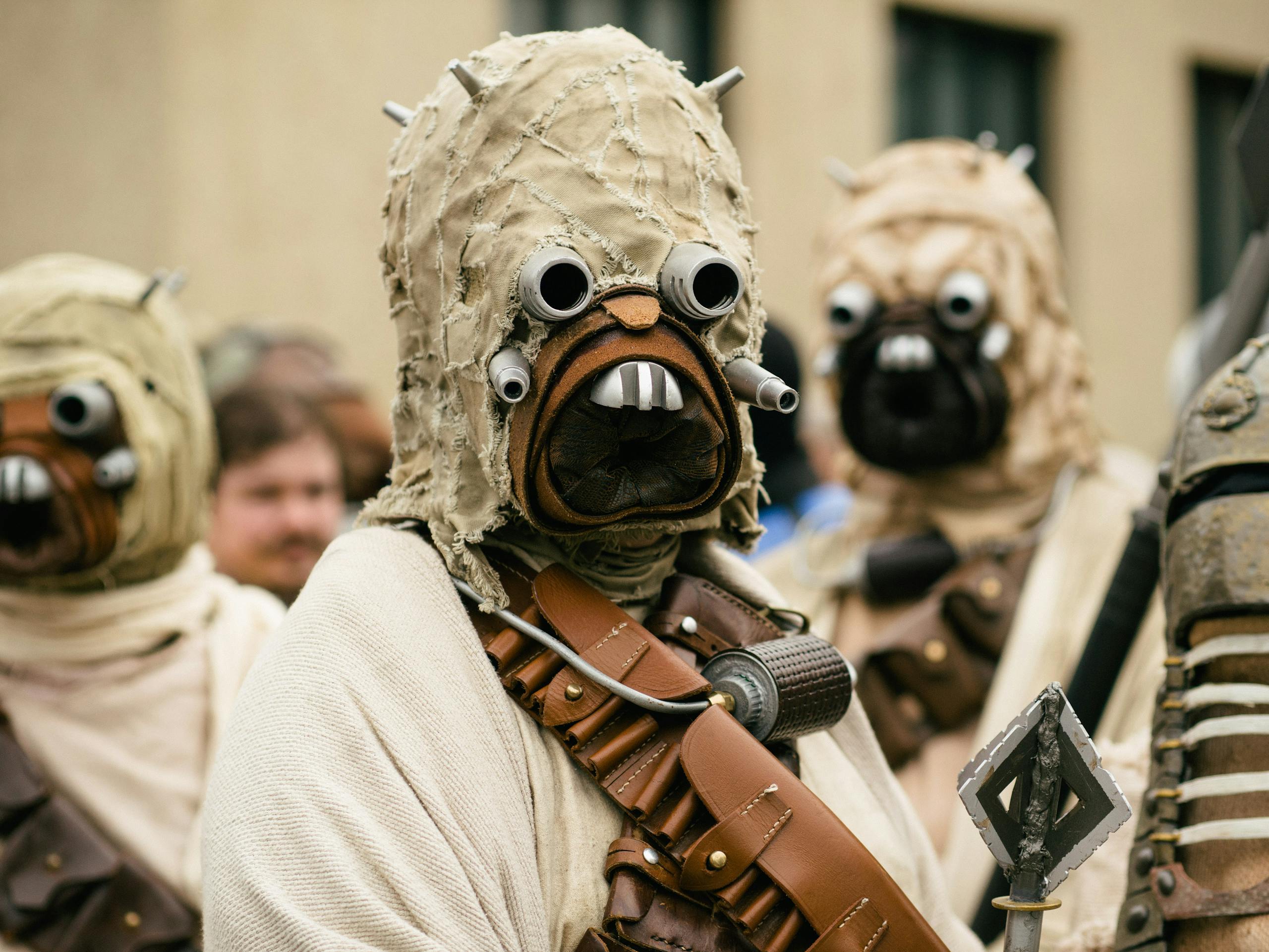 A group of people in detailed Star Wars cosplay costumes attending an outdoor event.