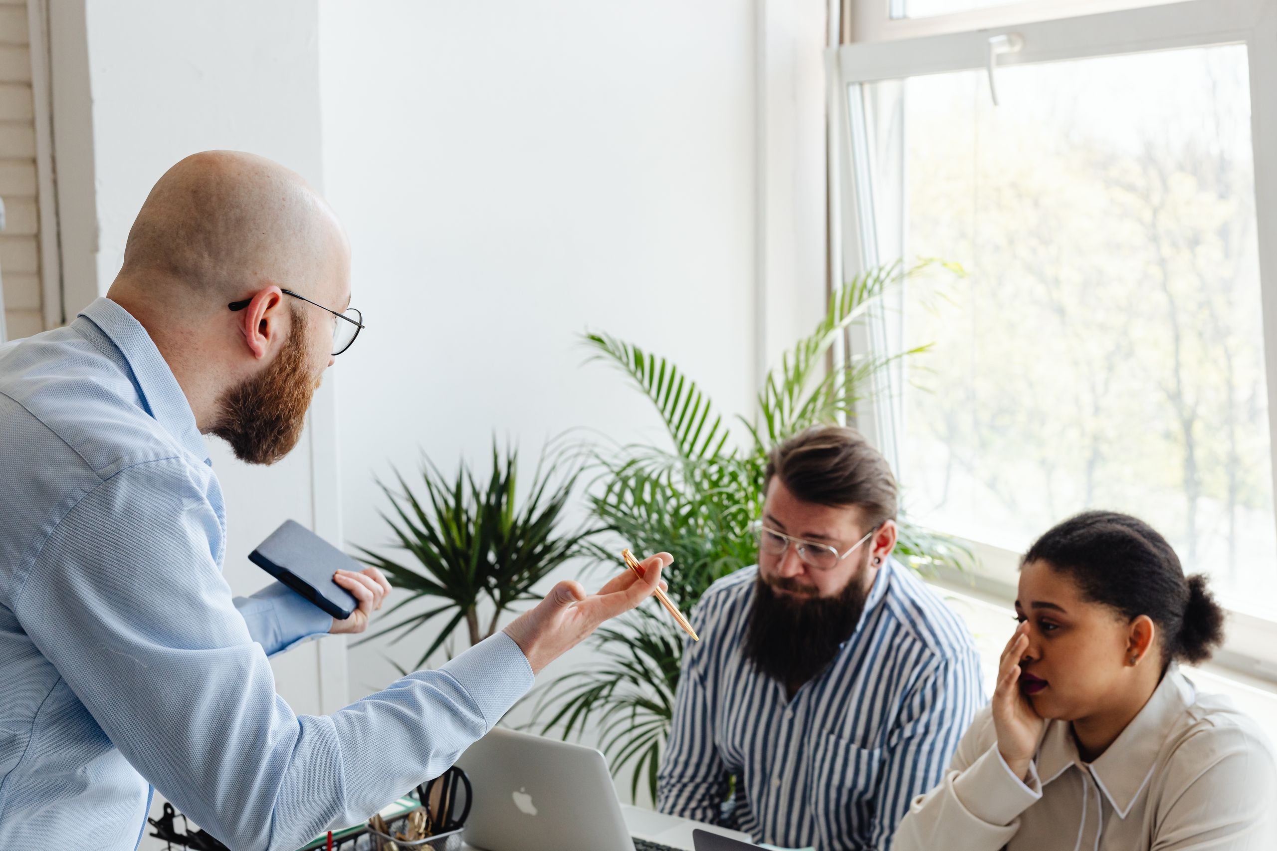 A heated discussion among colleagues in a bright office setting.