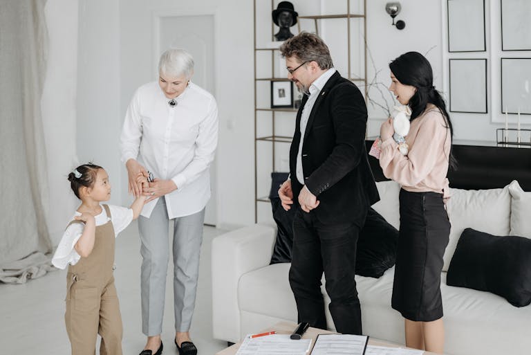 A joyful meeting of adoptive parents and child with a social worker in a modern interior.