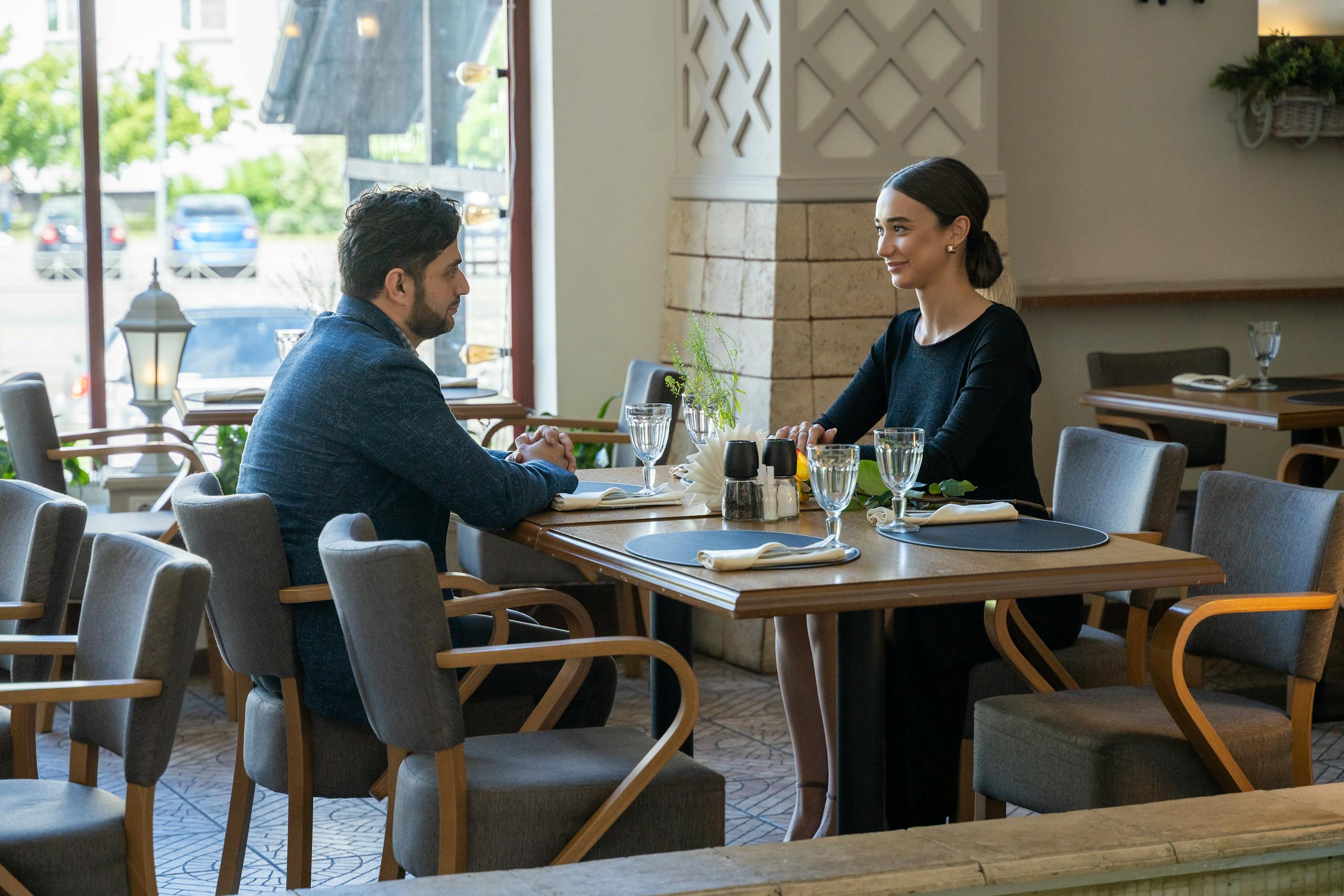 A man and woman enjoying a romantic meal in a cozy café setting, exuding warmth and connection.