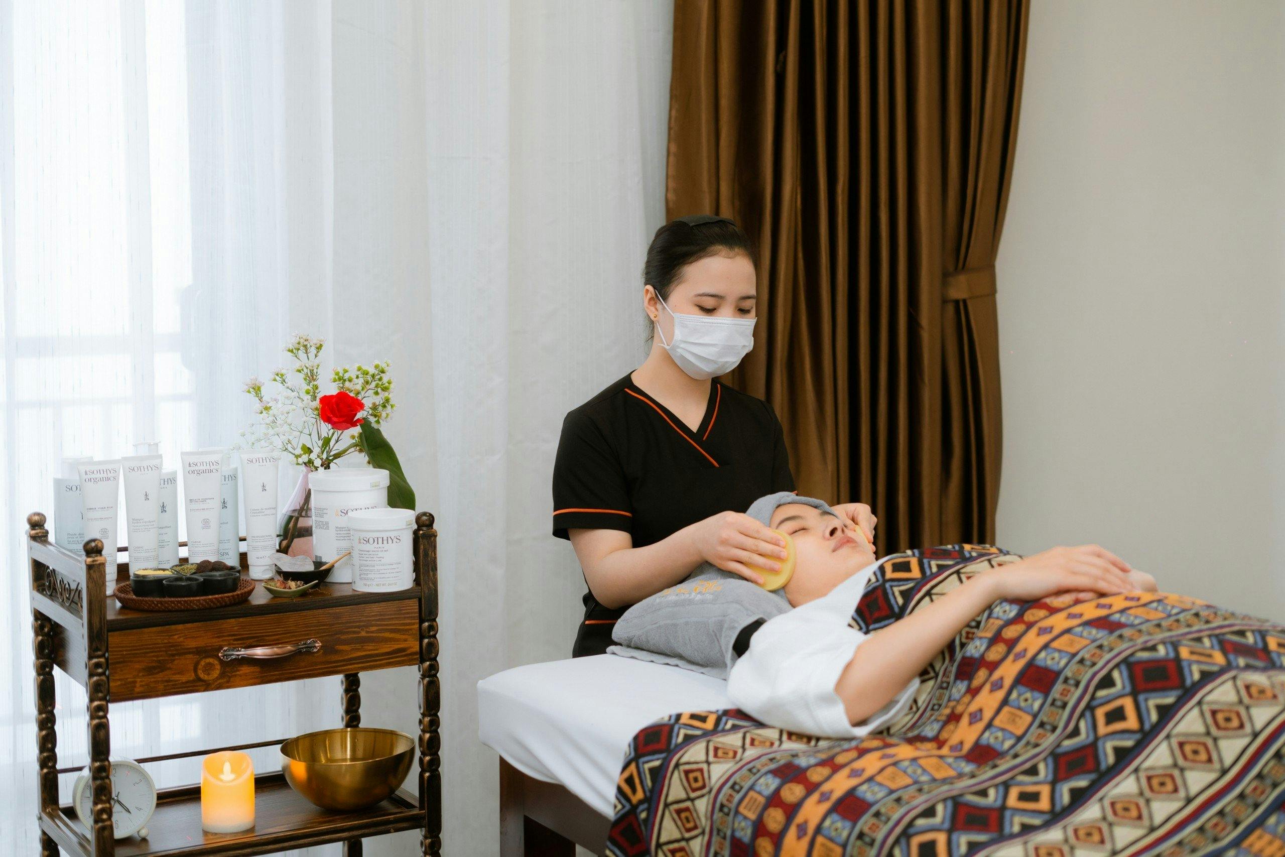 A serene spa experience with a therapist attending to a client's wellness needs indoors.
