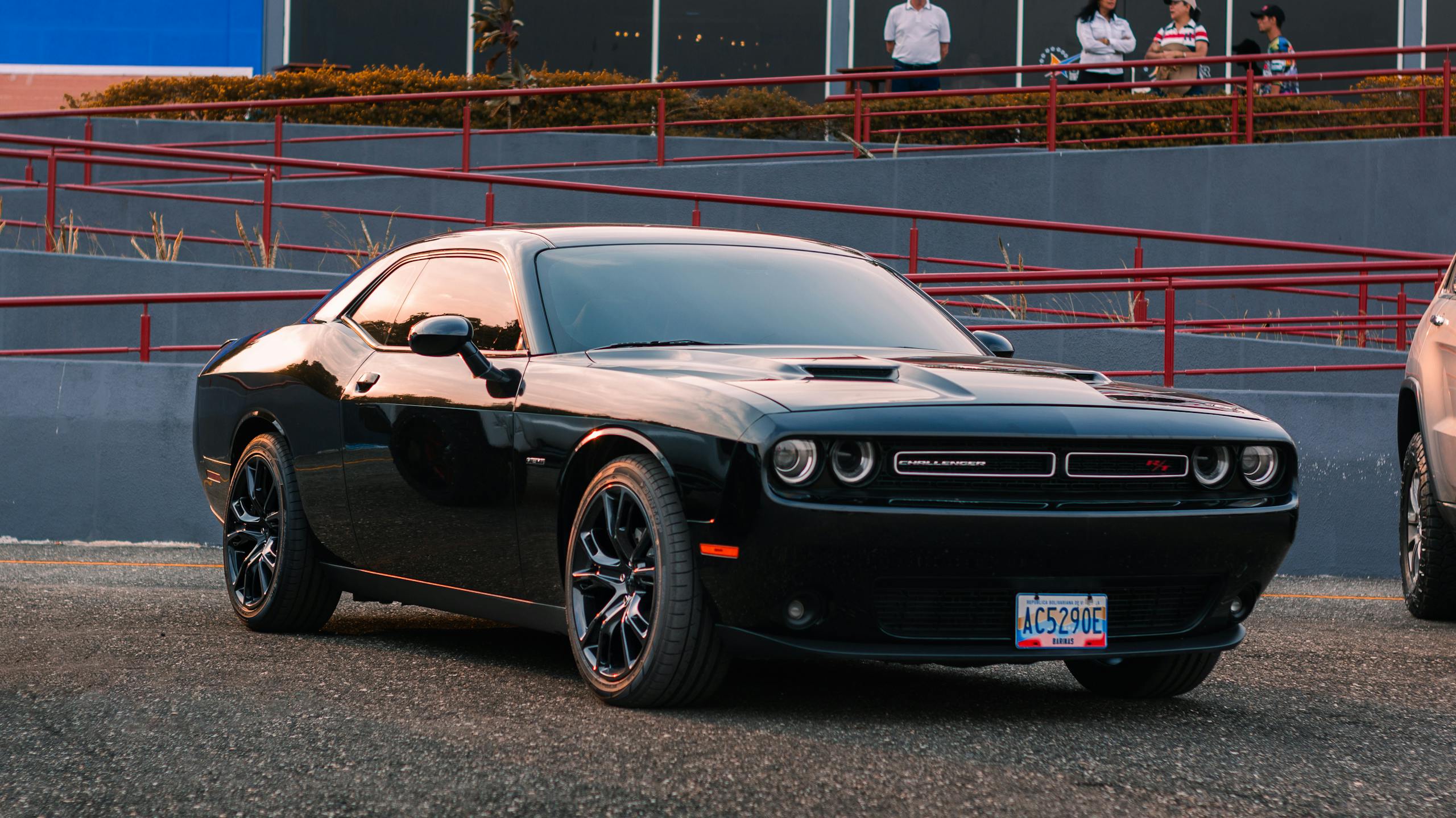 A stylish black Dodge Challenger parked outdoors, perfect for automotive enthusiasts.