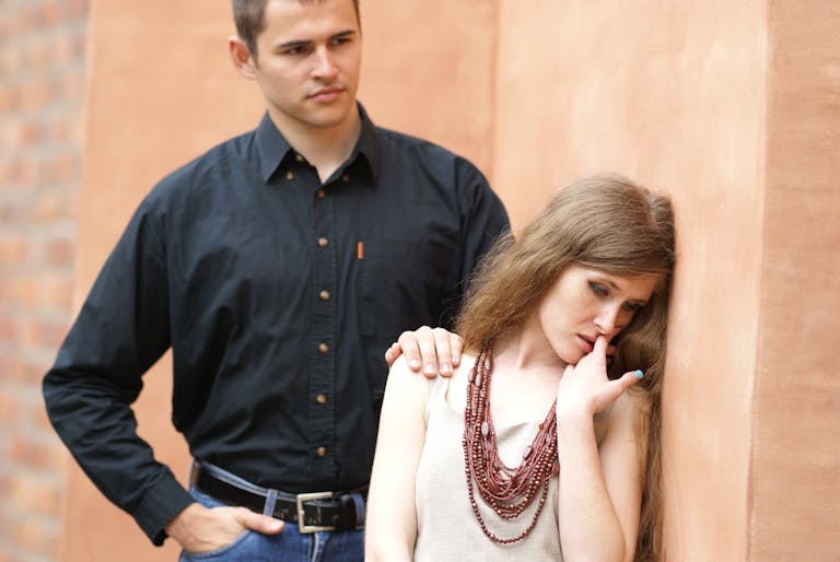 A thoughtful couple in a moment of intimacy and reflection indoors.
