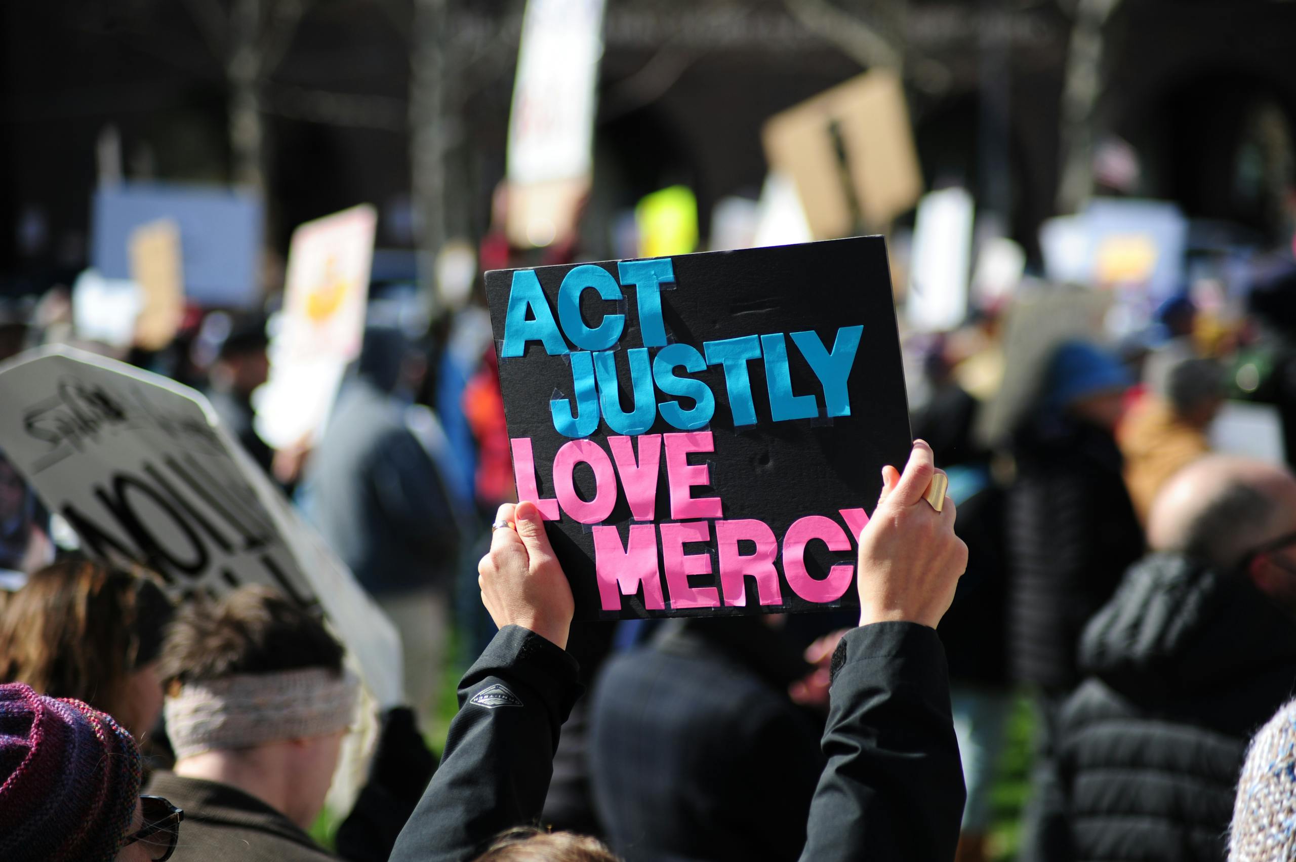 A vibrant street protest in Baltimore, Maryland promoting justice and mercy.