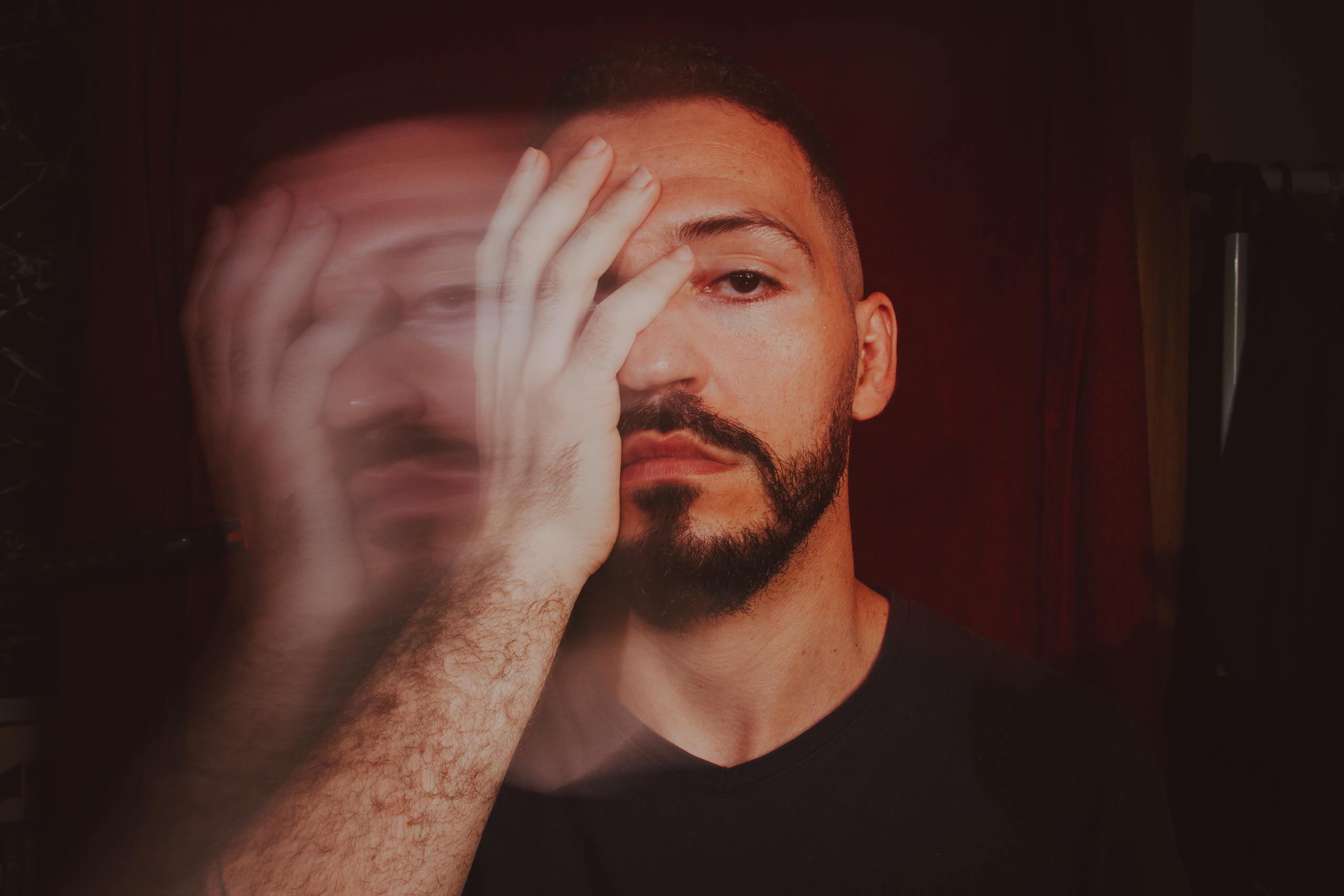 Artistic portrait showcasing a man with motion blur effect creating a moody and dramatic appearance.