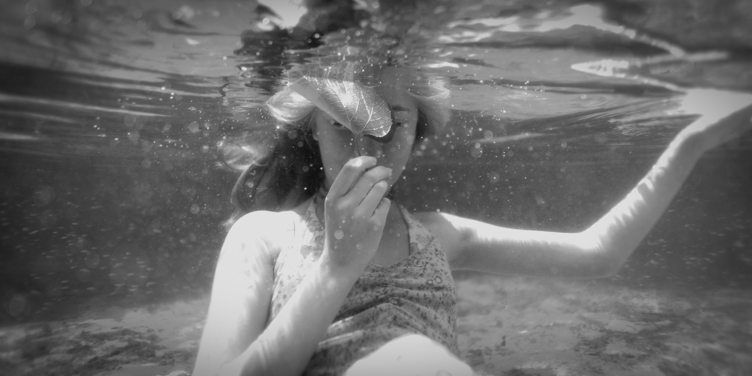 Artistic underwater photo of a woman, black and white style.