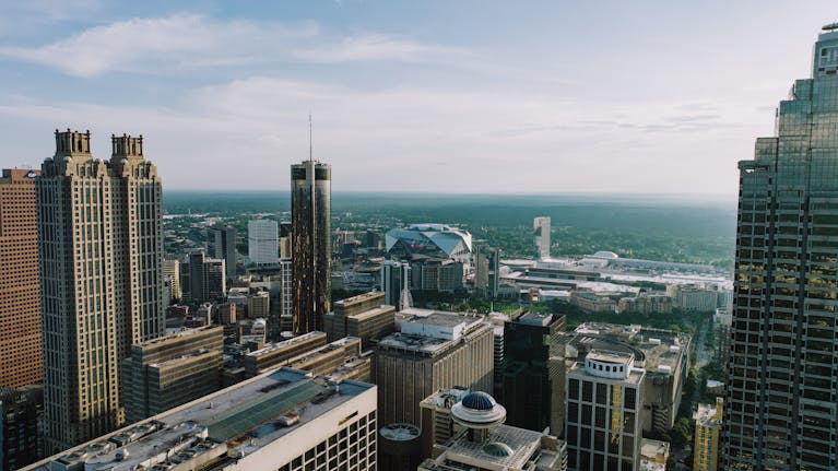 Breathtaking aerial view of Atlanta's skyline showcasing iconic buildings under a clear sky.