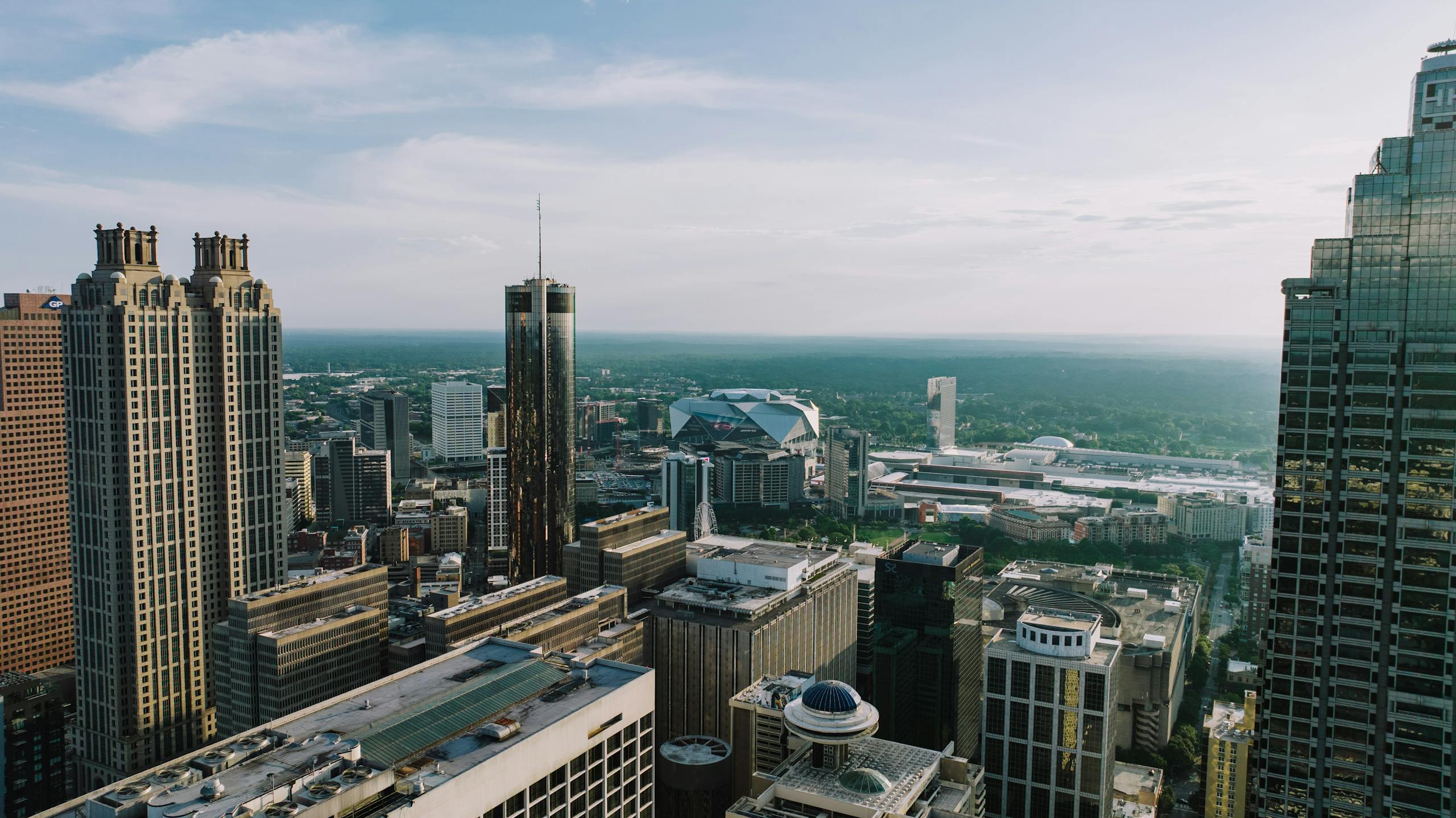 Breathtaking aerial view of Atlanta's skyline showcasing iconic buildings under a clear sky.