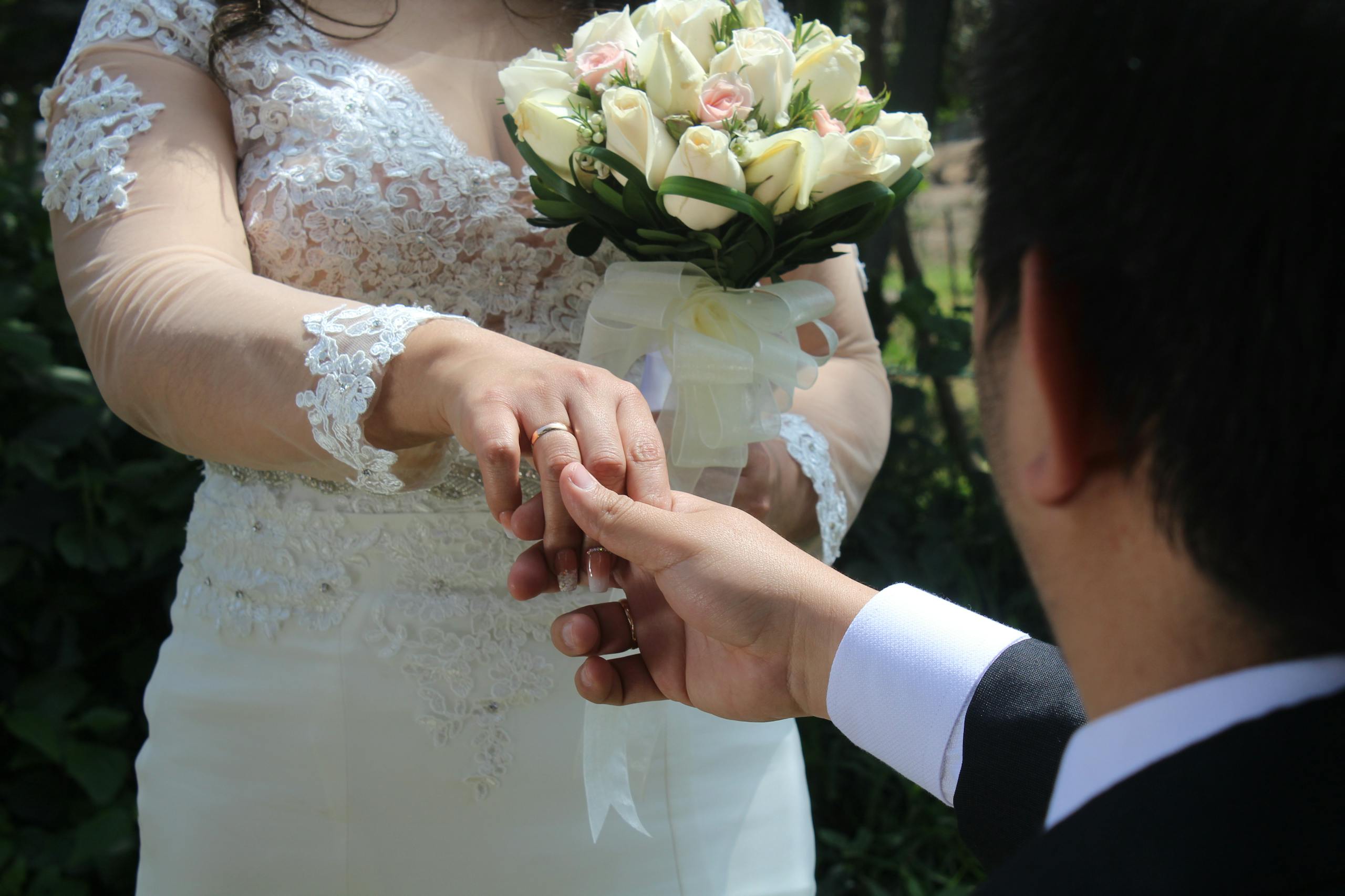 Bride and groom exchange rings in a tender outdoor wedding ceremony in Lima, Peru.