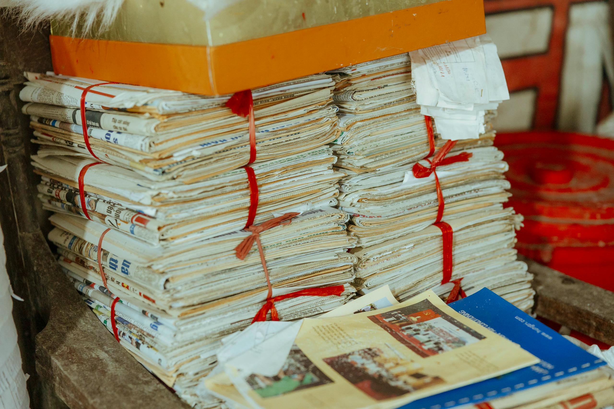 Bundles of newspapers bound together, showcasing vintage reading material.