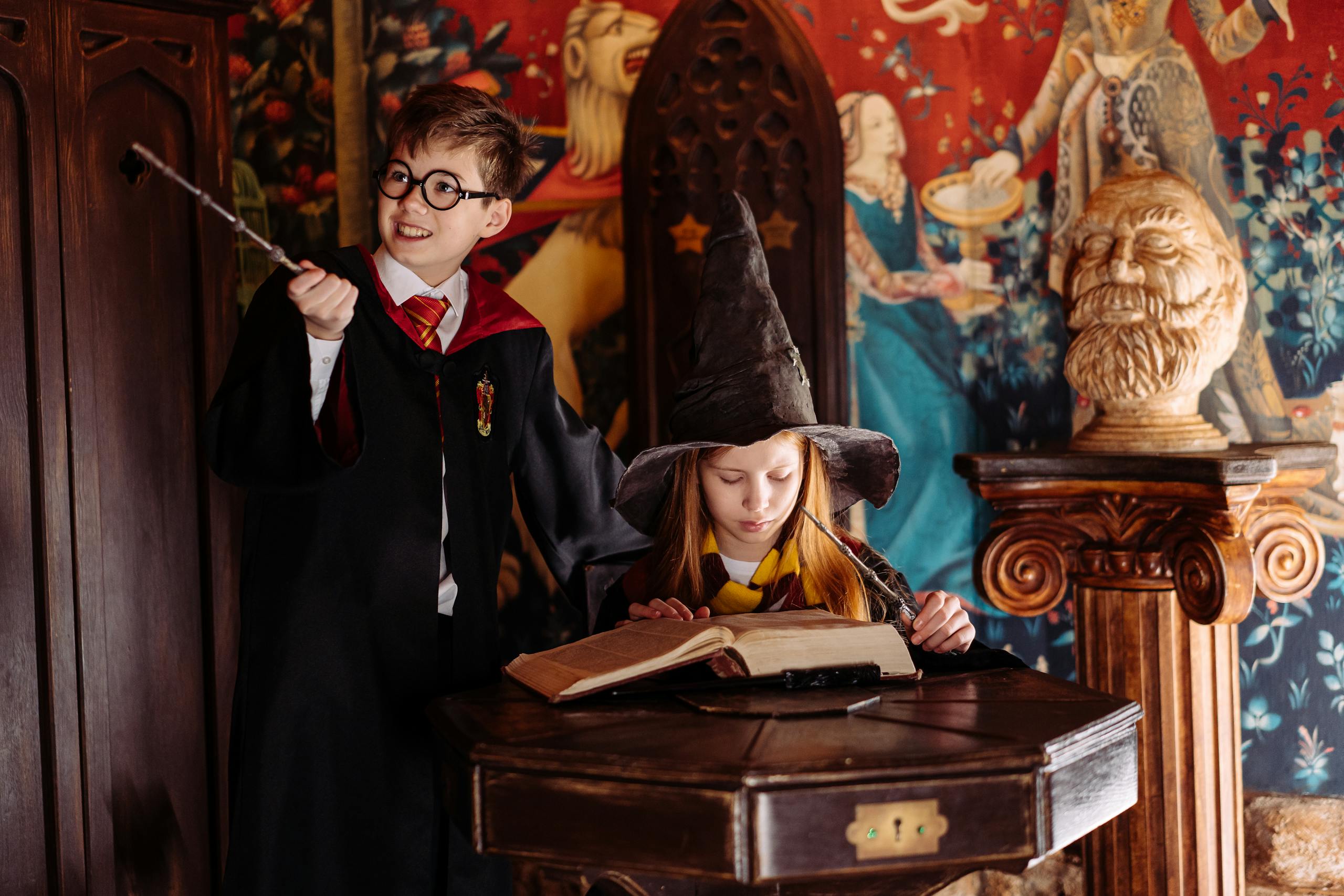 Children dressed as wizards engaged in magic-themed play, exploring spells in a fantasy setting.