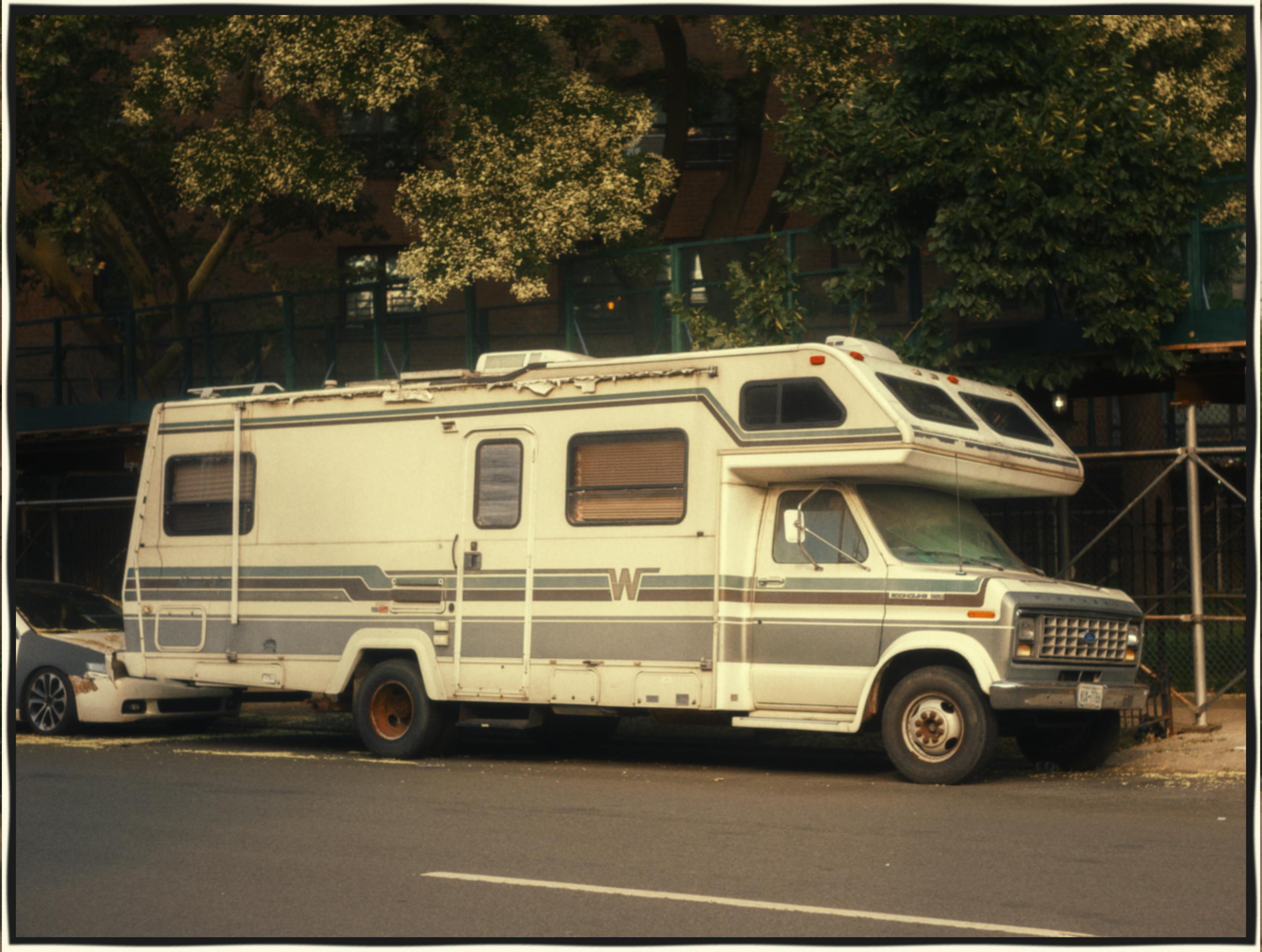 Classic Winnebago RV parked on a city street, exemplifying urban camping adventure.