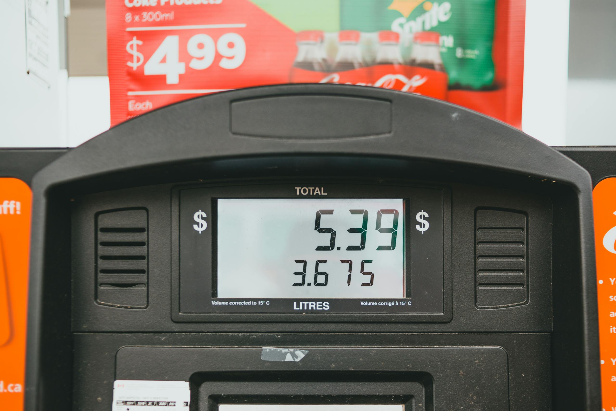 Close-up of a gas pump display showing price per liter and total volume during a transaction.