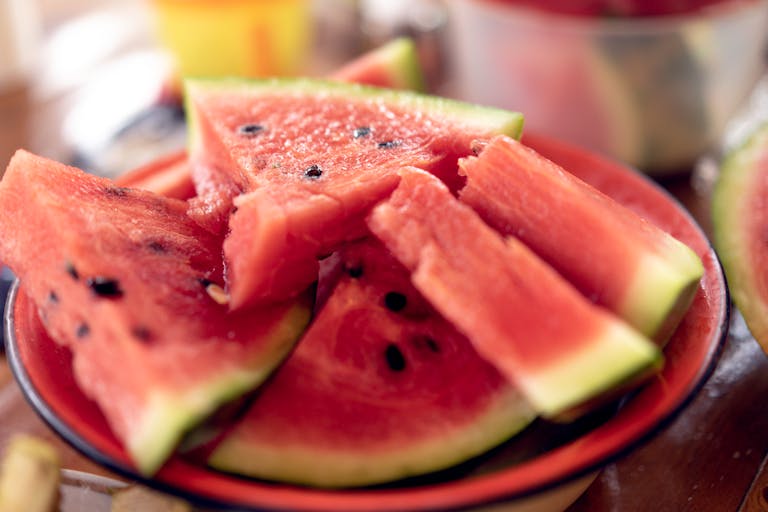 Close-up of fresh, sliced watermelons on a plate perfect for summer refreshment.