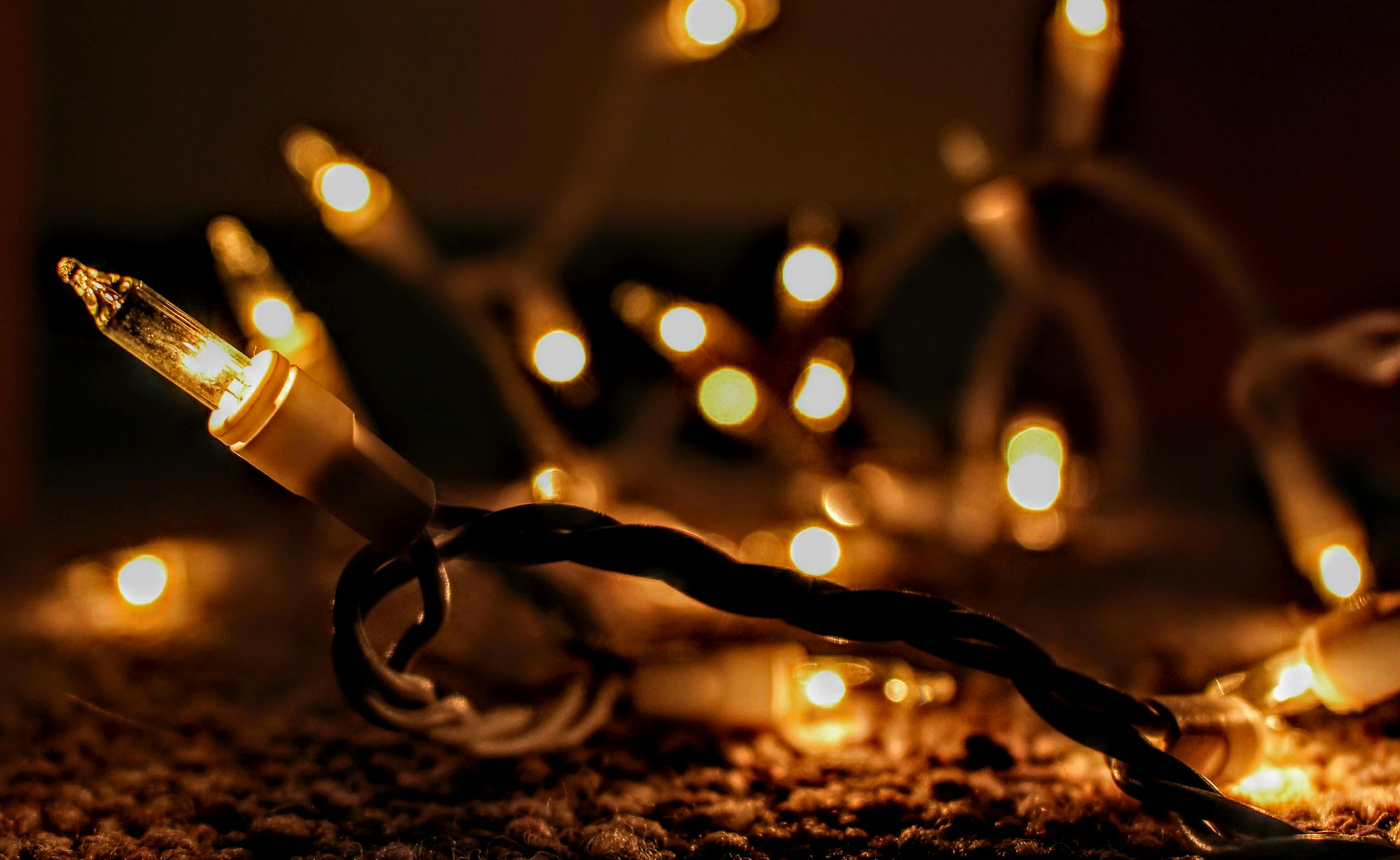Close-up of warm glowing string lights creating a cozy ambiance with bokeh.
