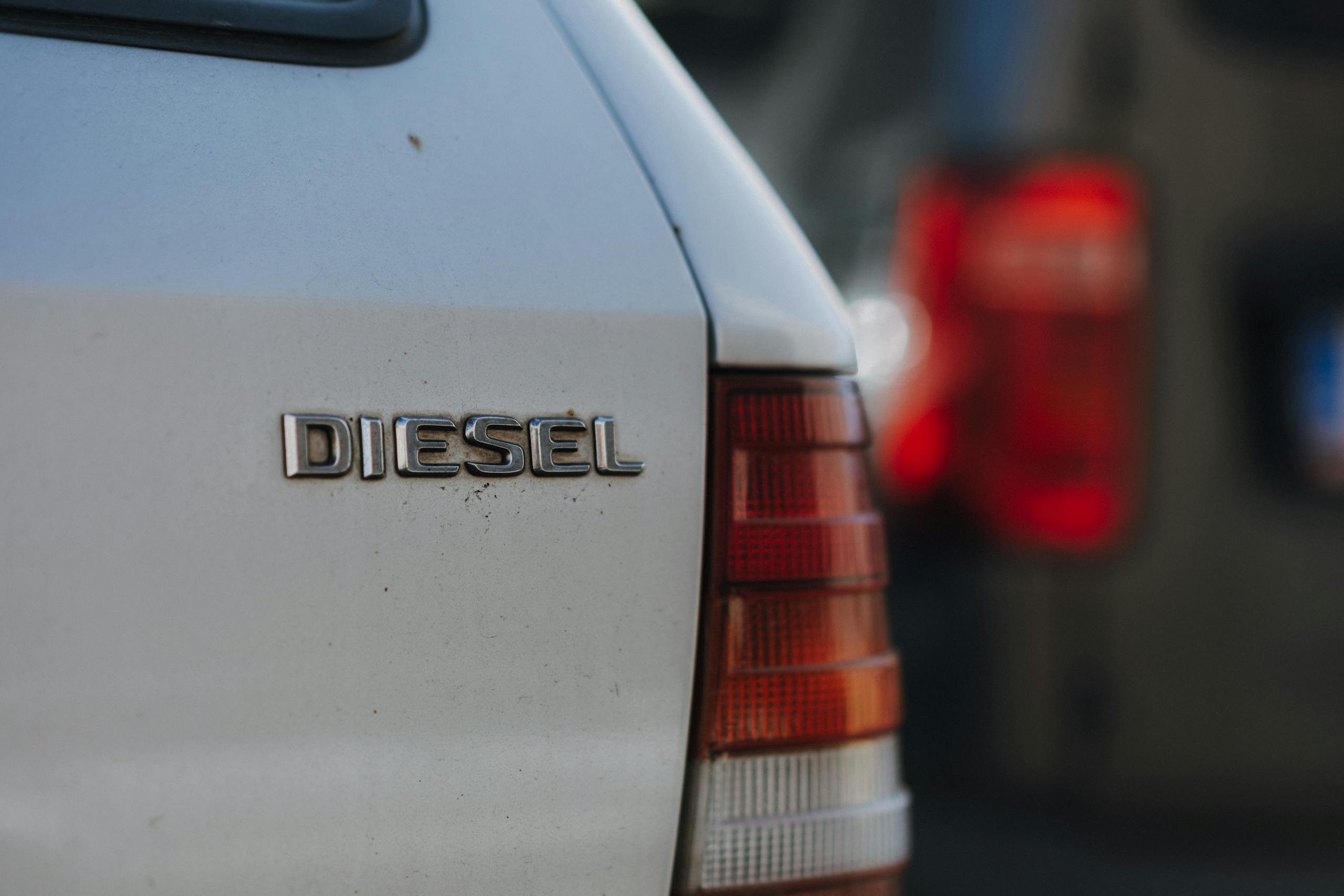 Detailed view of a diesel car badge with blurred background, captured in Prague.