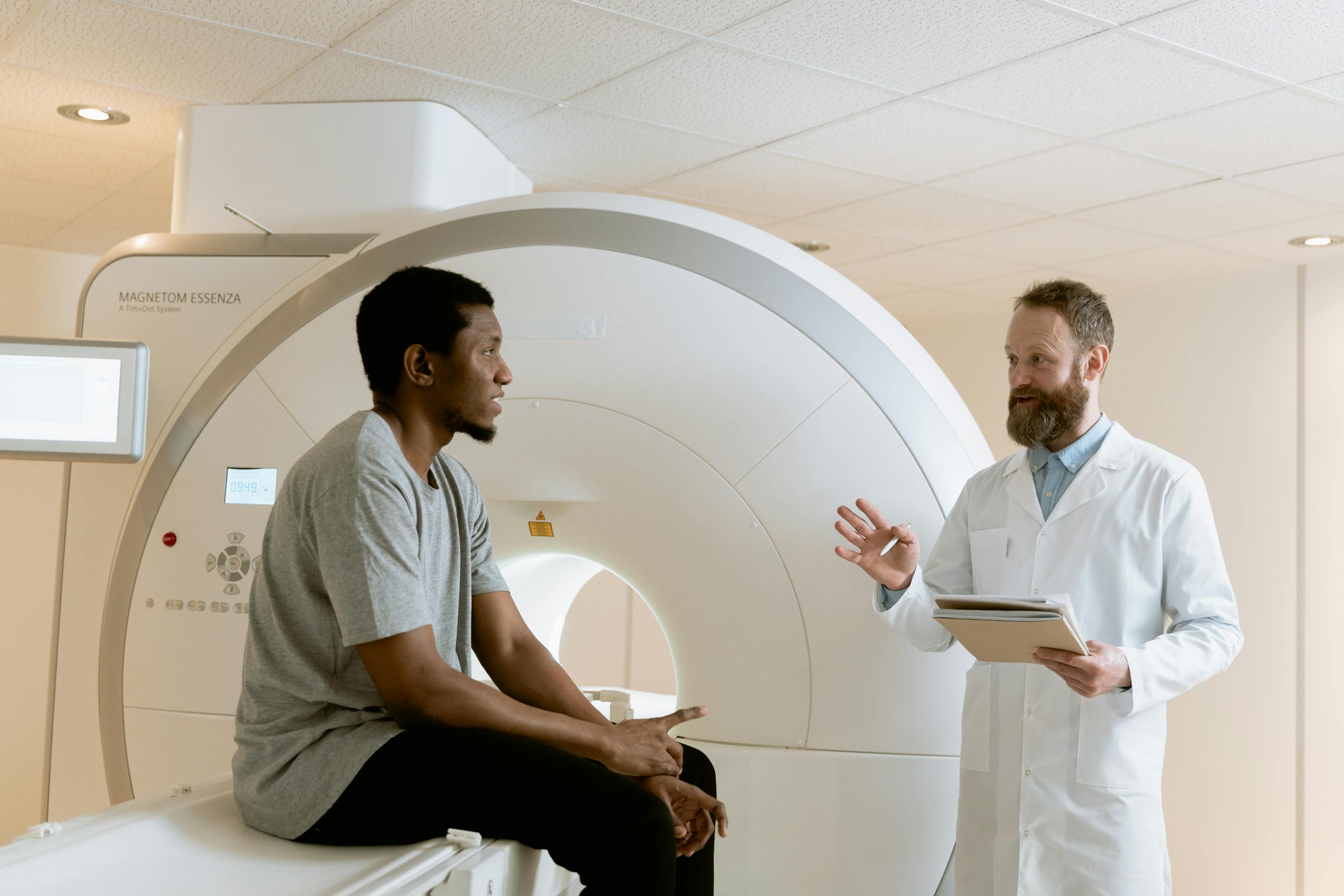 Doctor discussing MRI scan results with patient in a medical facility.