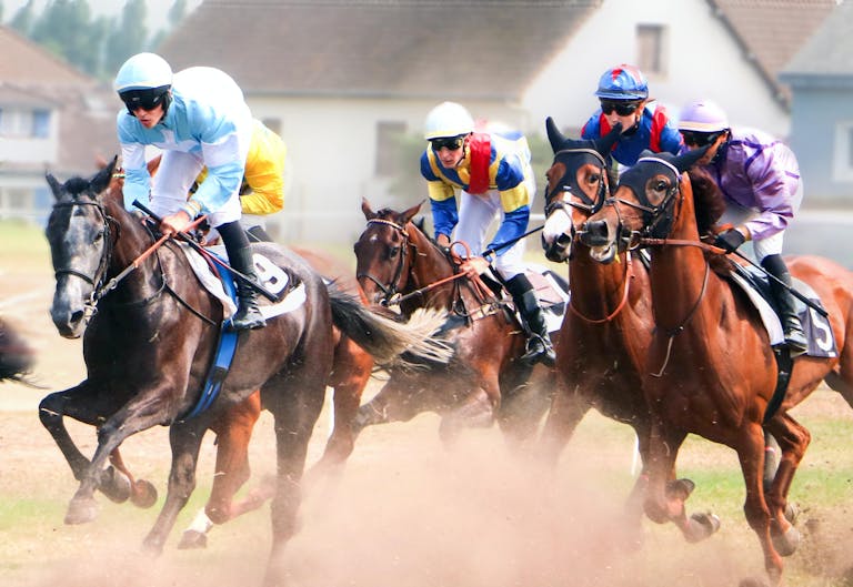 Dynamic action shot of a horse race in Bréhal, Normandie, capturing intense competition.
