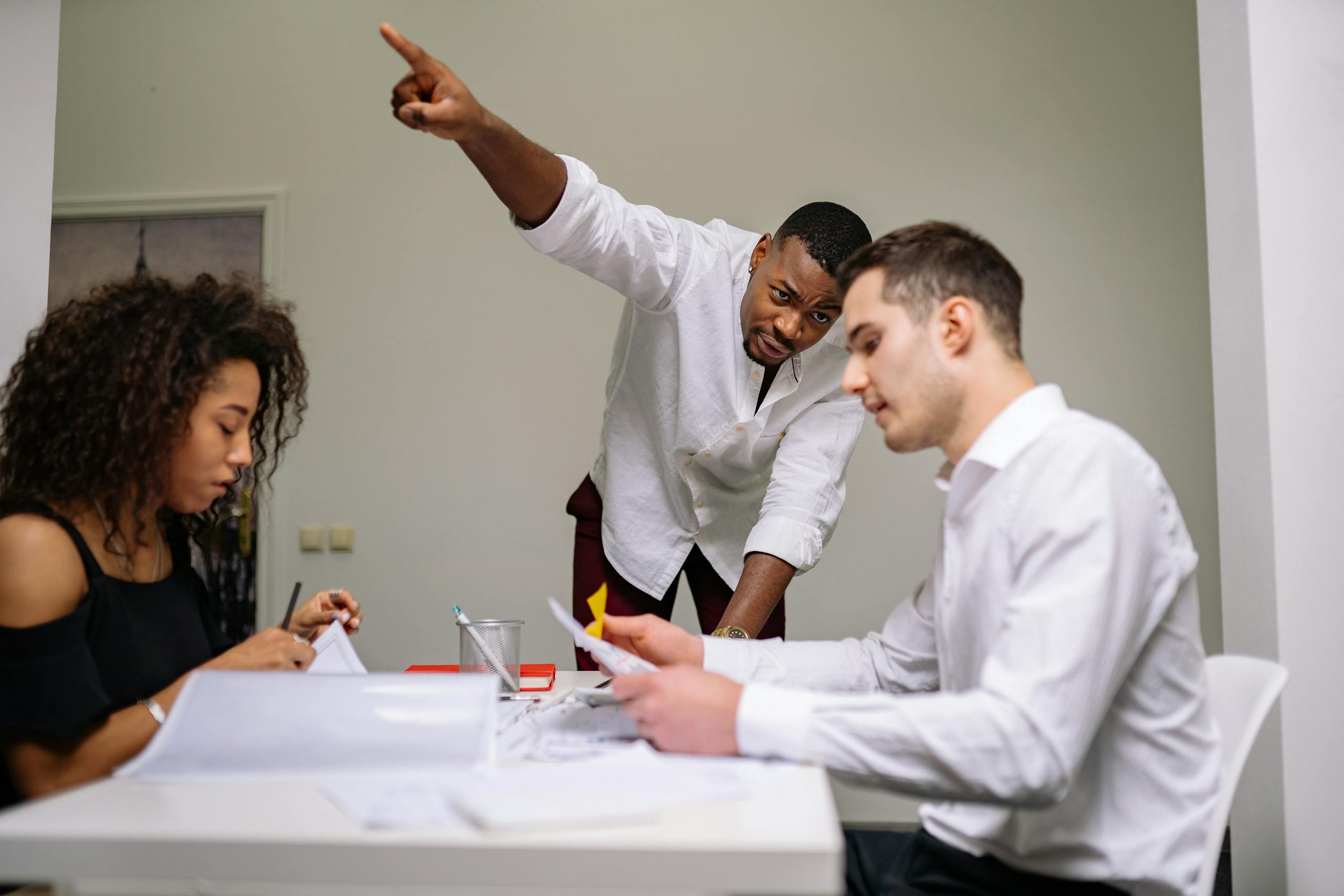 Dynamic office setting with diverse team members actively engaged in a discussion.