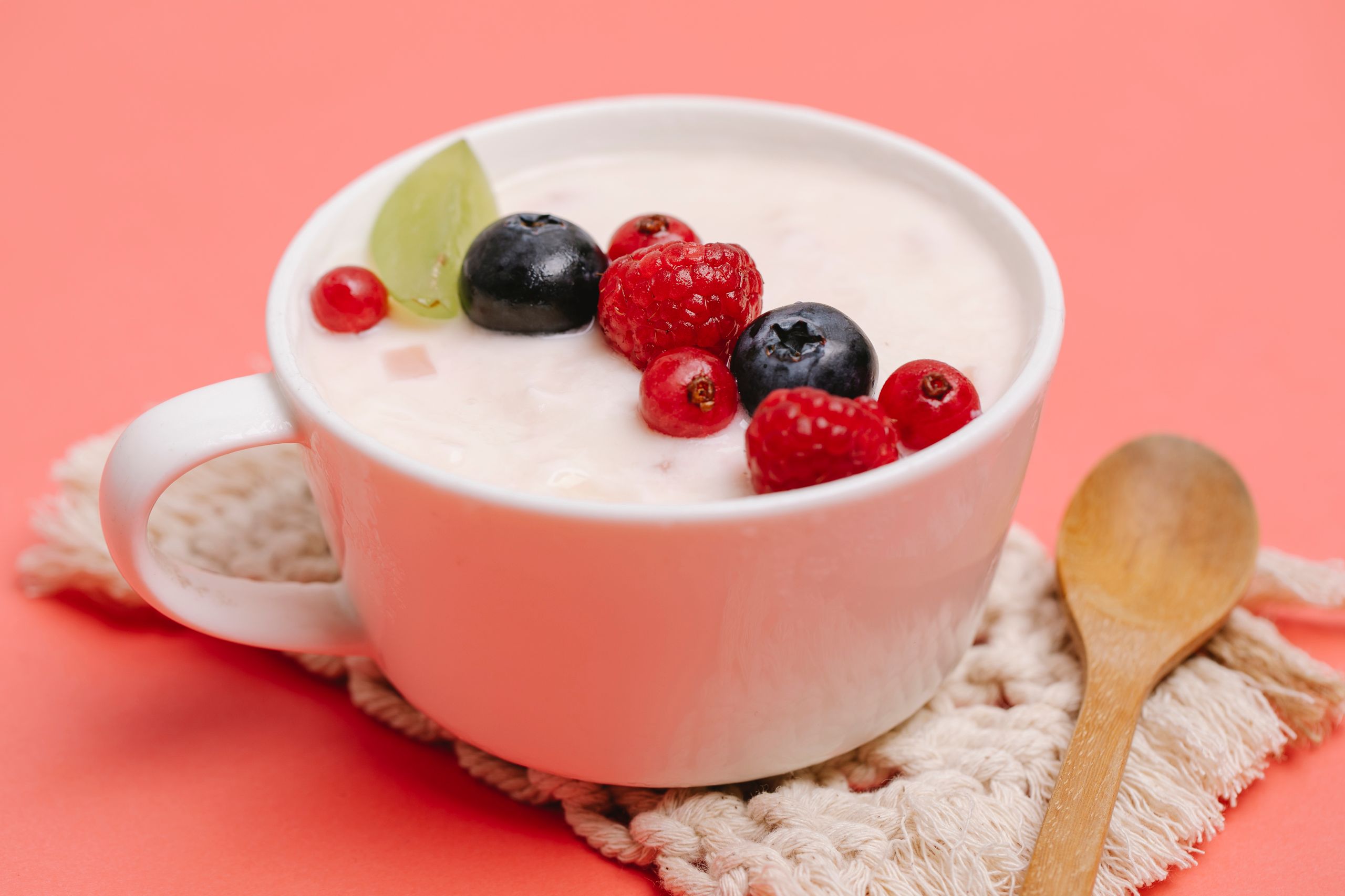 From above of appetizing sweet dessert with tasty berries served on table with spoon