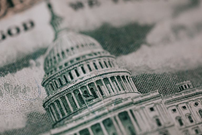 From above of photo of historic Capitol of USA Congress in neoclassical style with columns and dome represented on paper money