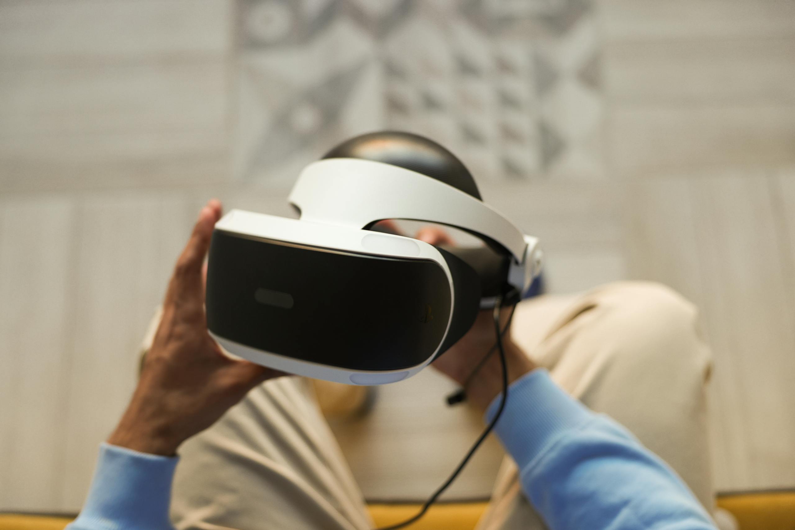 Hands holding VR headset for immersive virtual reality experience.