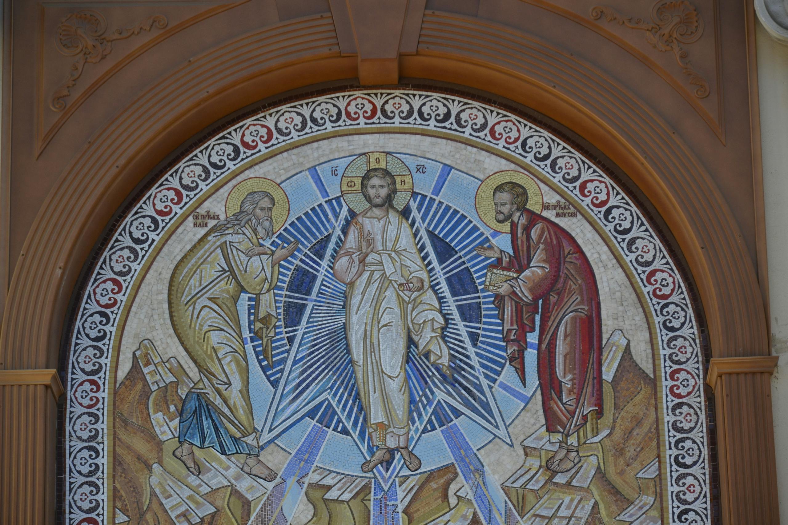 Intricate religious mosaic art depicting three figures in a church setting.