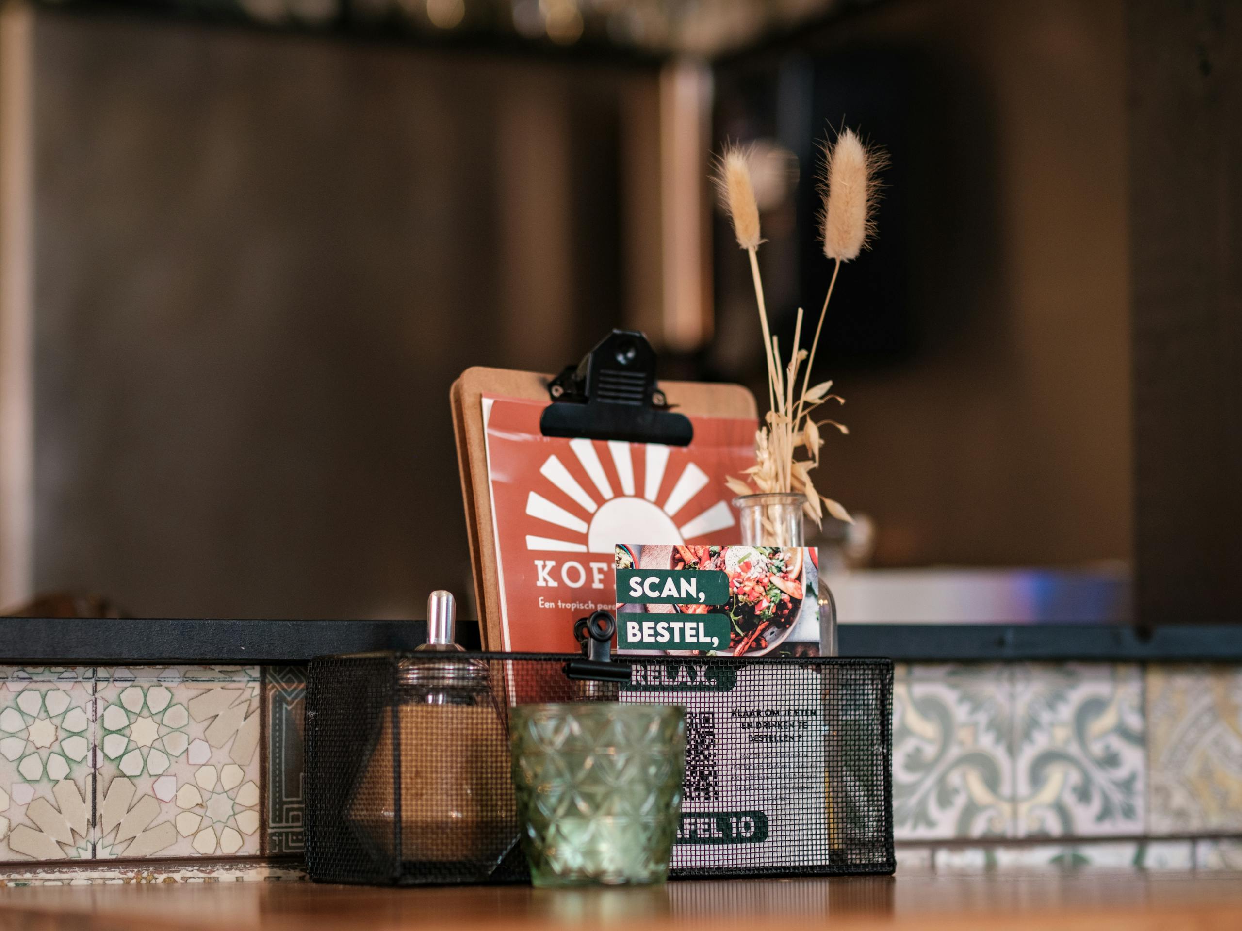 Inviting cafe table with rustic decor, menu card, and ambient candlelight in a cozy restaurant.