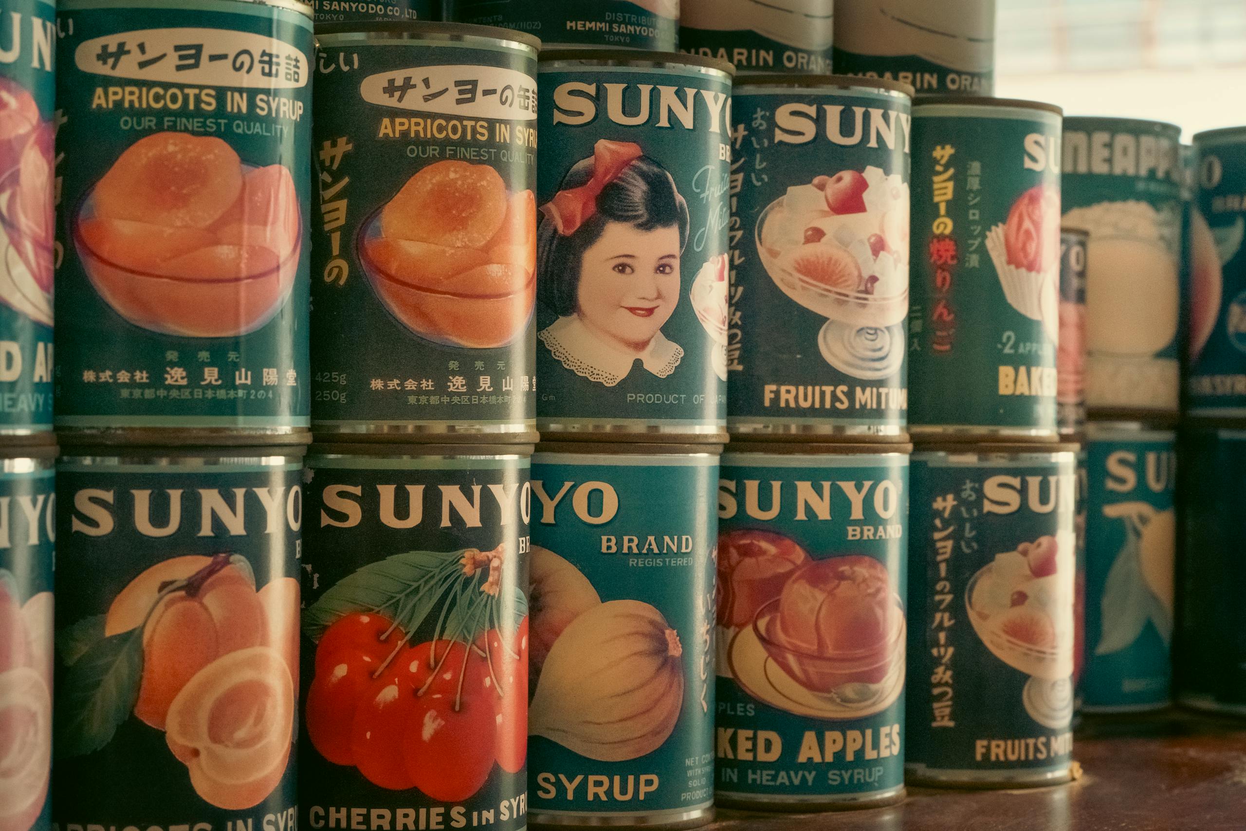 Nostalgic display of vintage Japanese SUNYO brand canned fruits. Perfect for retro and vintage-themed projects.