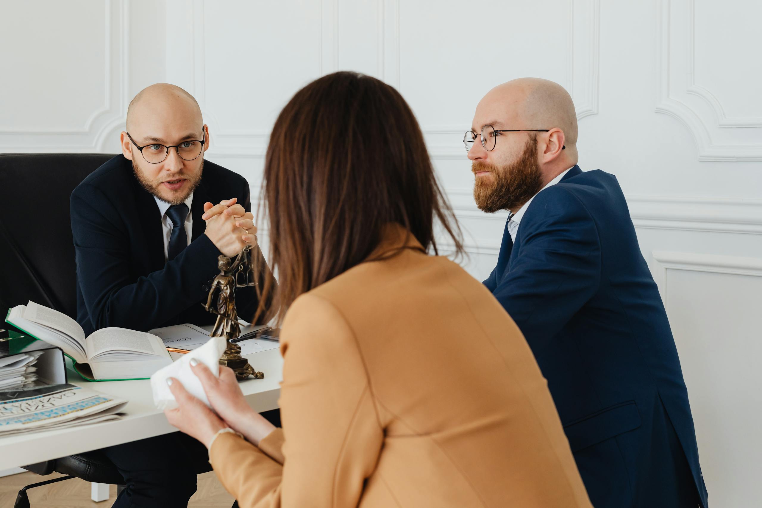 Professional discussion among lawyers in a modern office, focusing on legal matters.