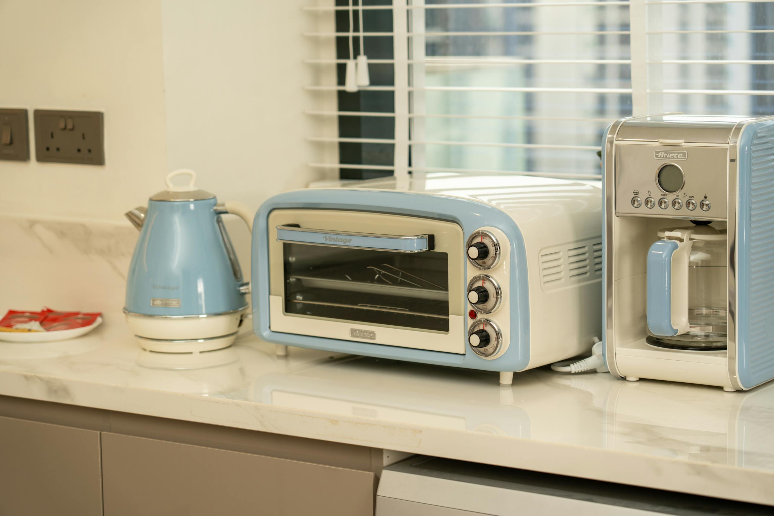 Retro-style kitchen appliances in a modern setting with blue accents.