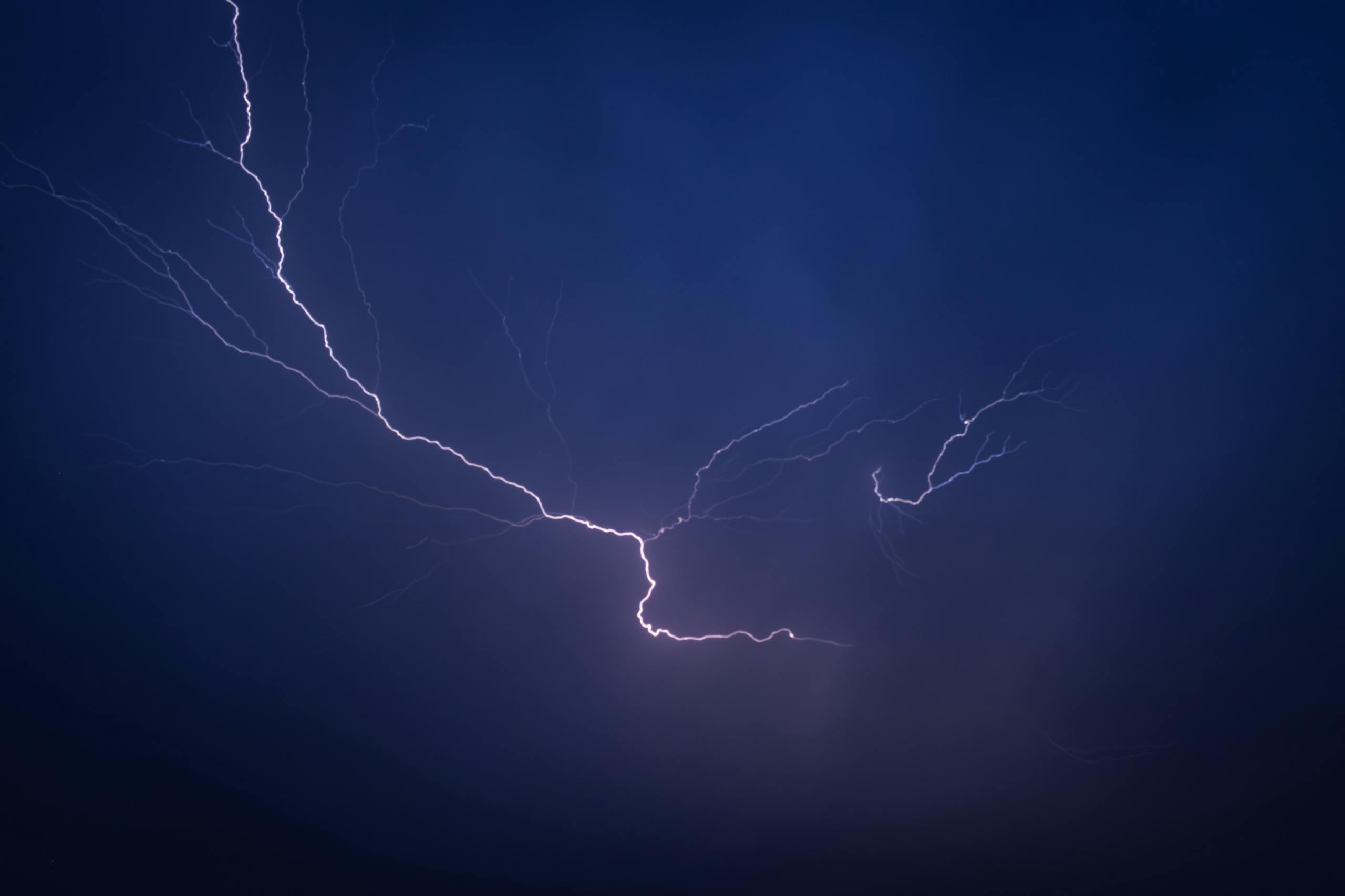 A striking lightning bolt captured at night in a dramatic display of nature's power.