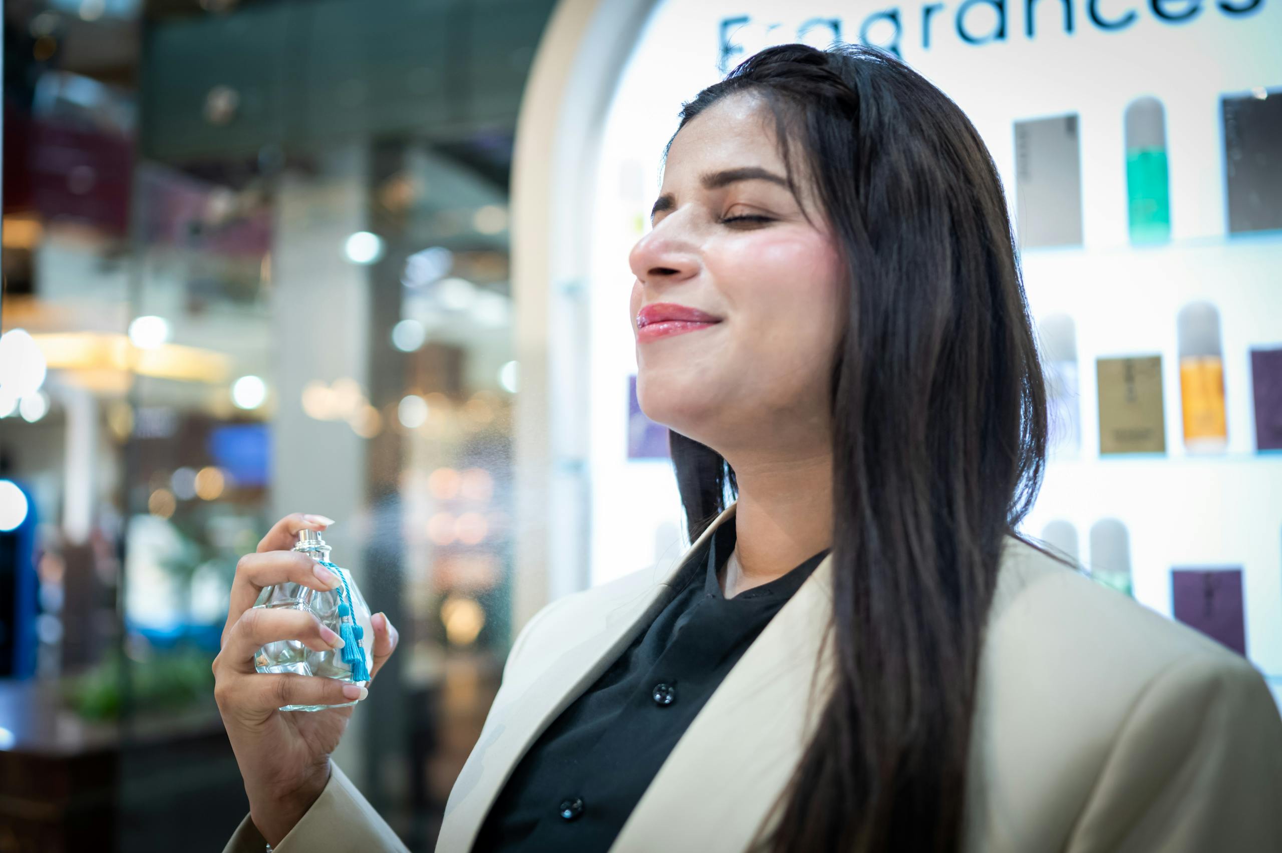A stylish woman savoring a fresh fragrance in an Islamabad boutique.