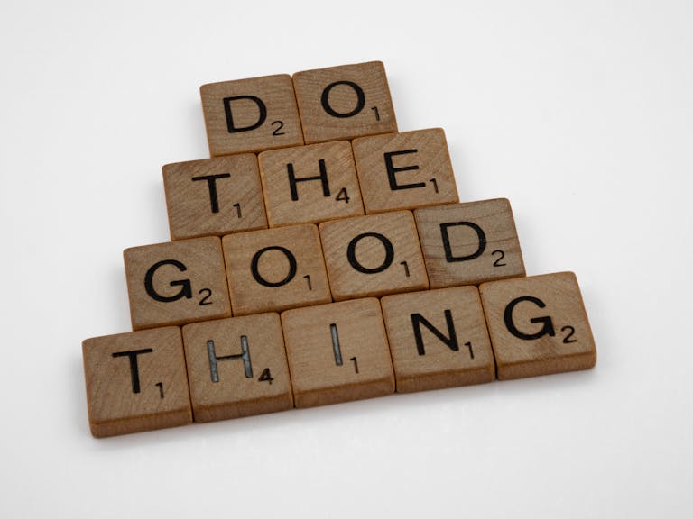 Wooden tiles arranged to spell 'Do The Good Thing,' promoting positive action.