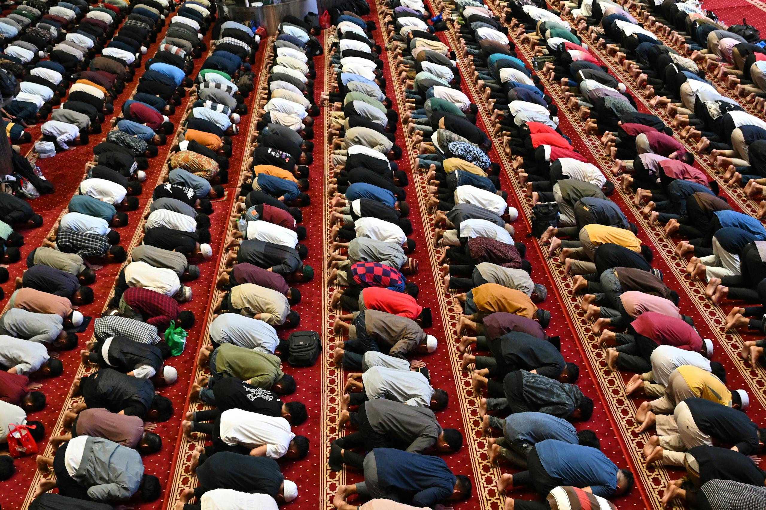 Worshipers in rows performing prayer at a mosque in Jakarta, Indonesia.