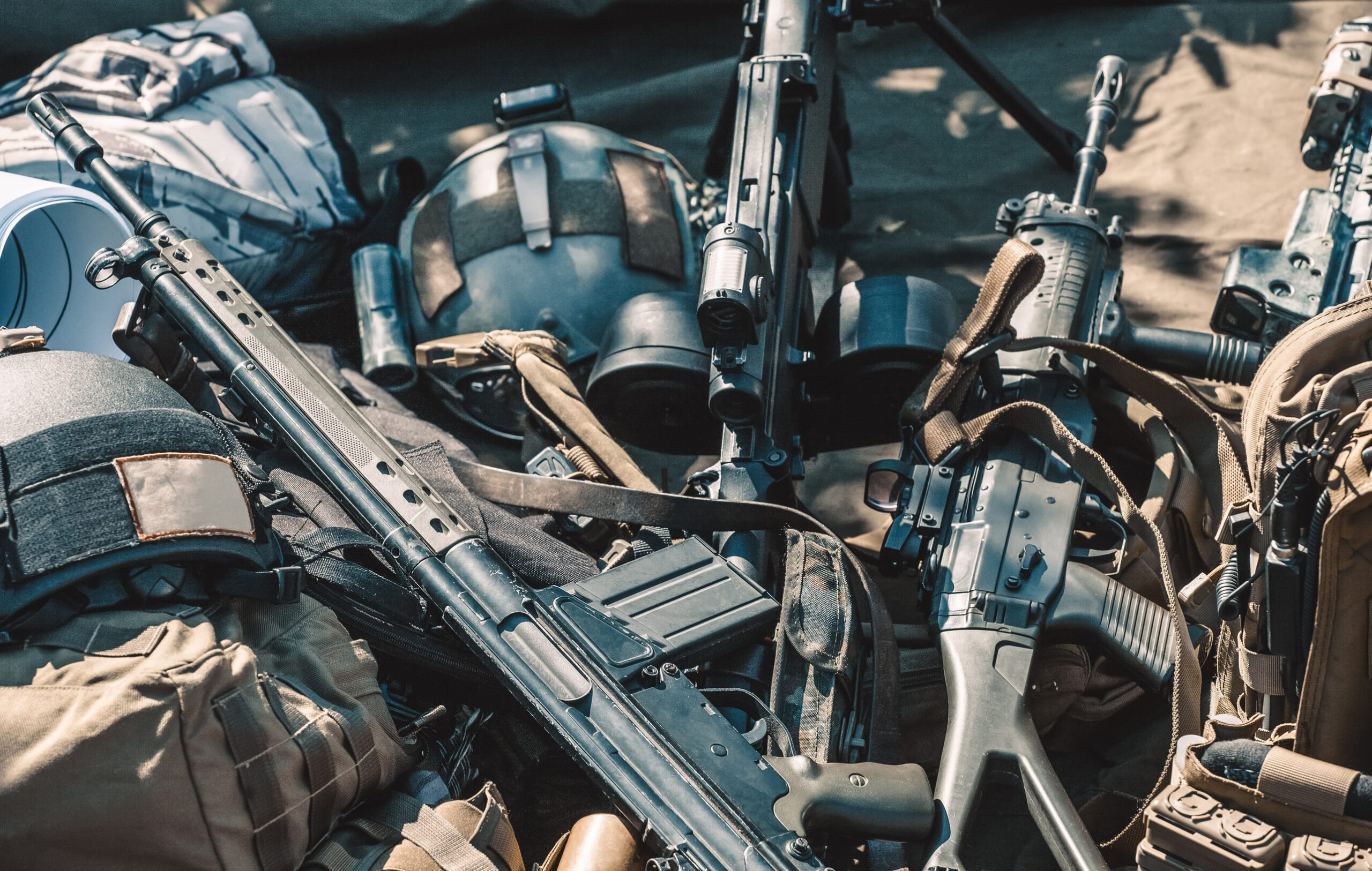 automatic machine, machine gun, helmet, body armor piled in a heap lie on the ground.