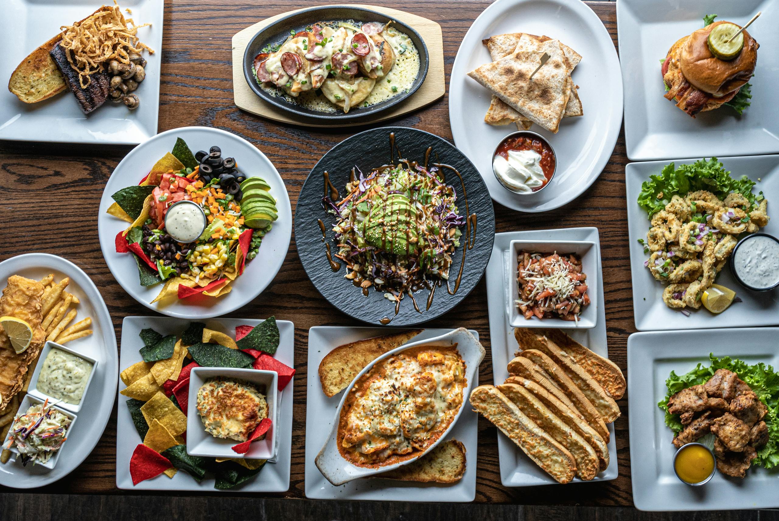 A colorful assortment of gourmet dishes, offering a top view of diverse culinary treats.
