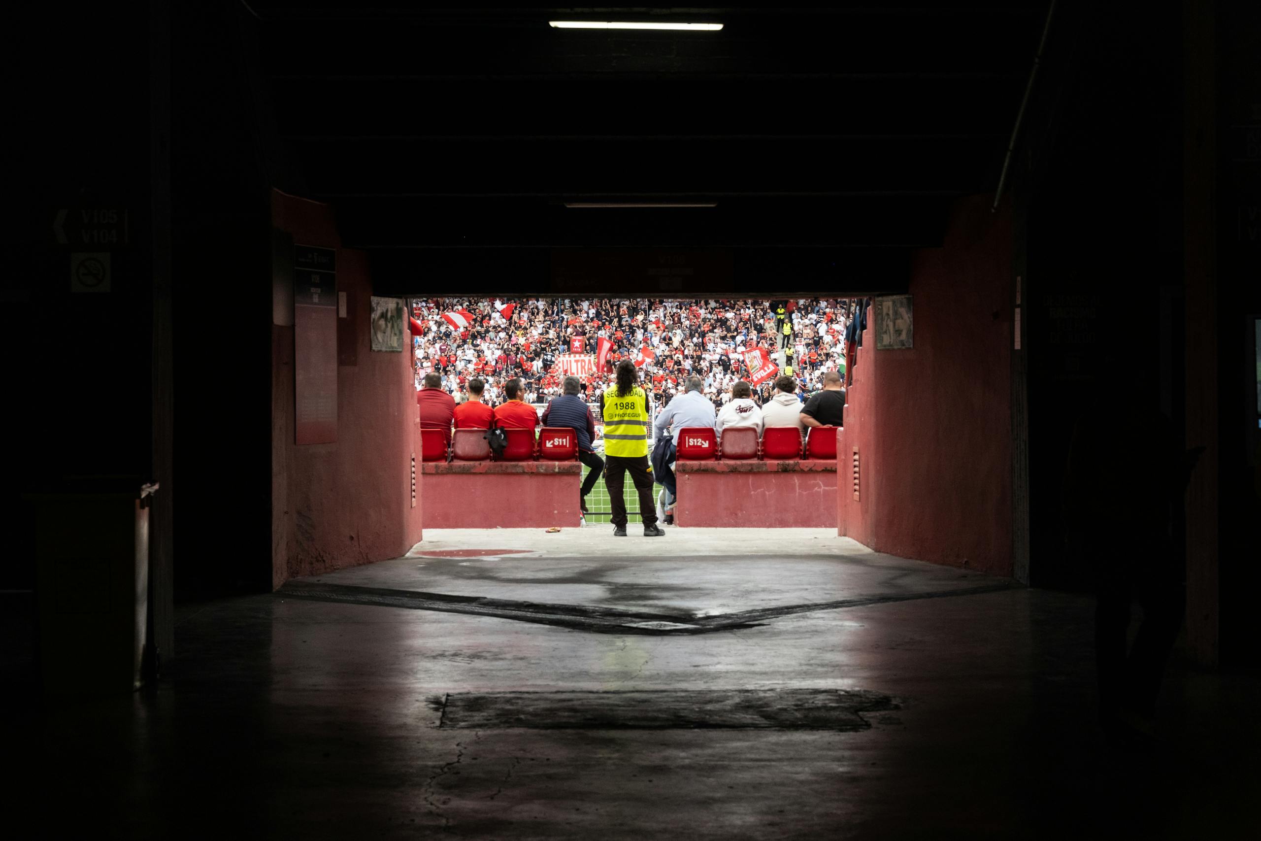 A dynamic stadium perspective through the tunnel showcasing engaged spectators during a game.