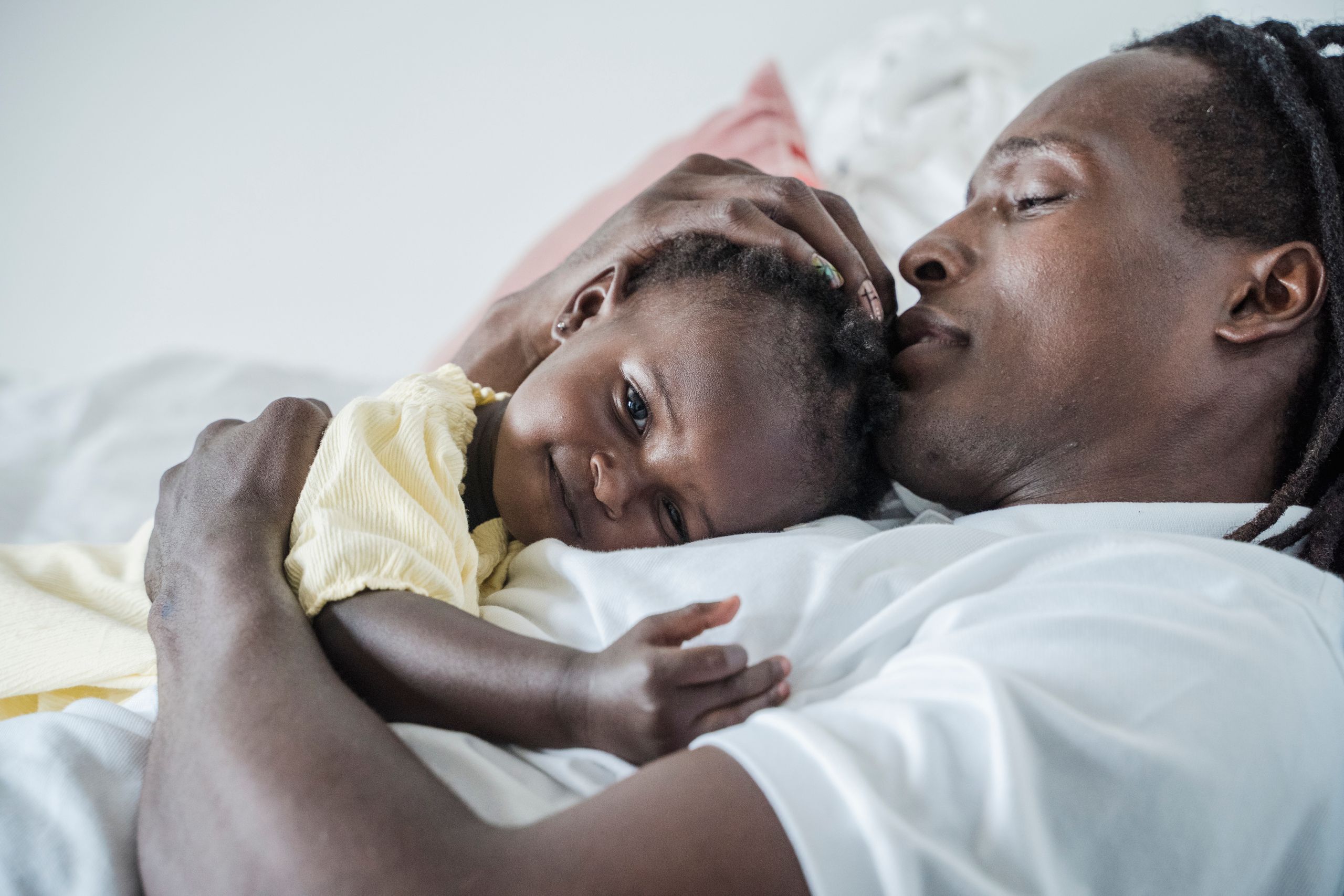 A father and child share a heartfelt embrace, capturing a moment of love and tenderness.