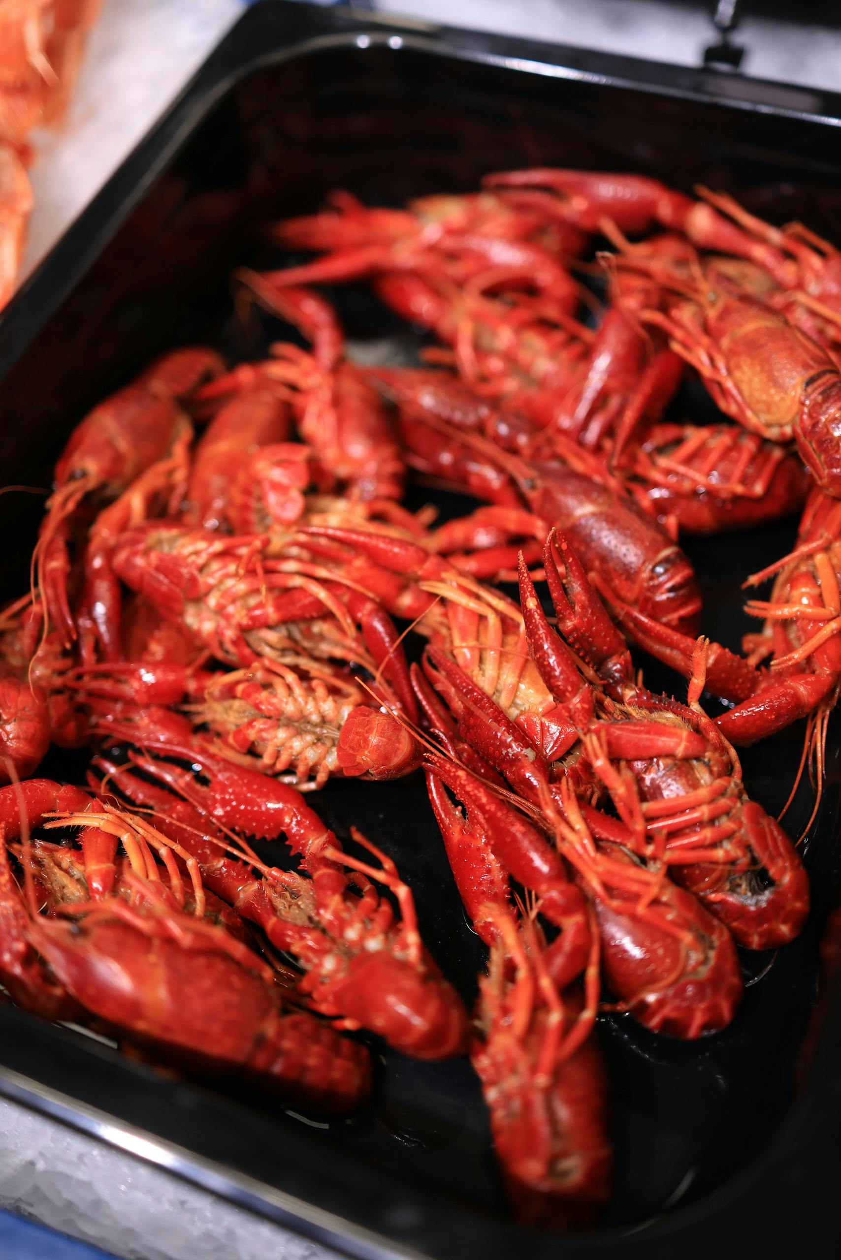 A heaping tray of boiled crawfish ready for a seafood feast.