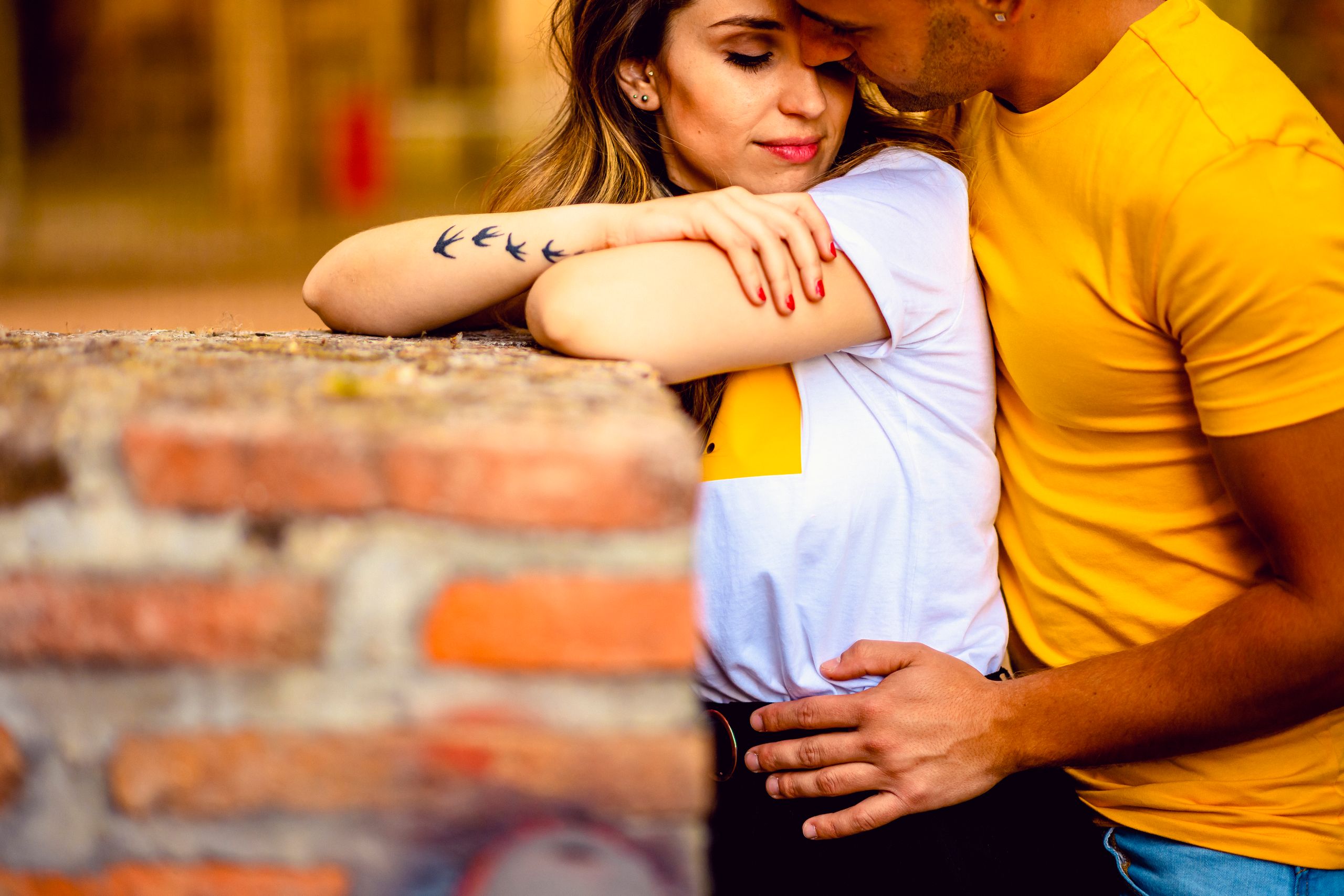 A loving couple in a warm embrace in the streets of Toledo, Spain.