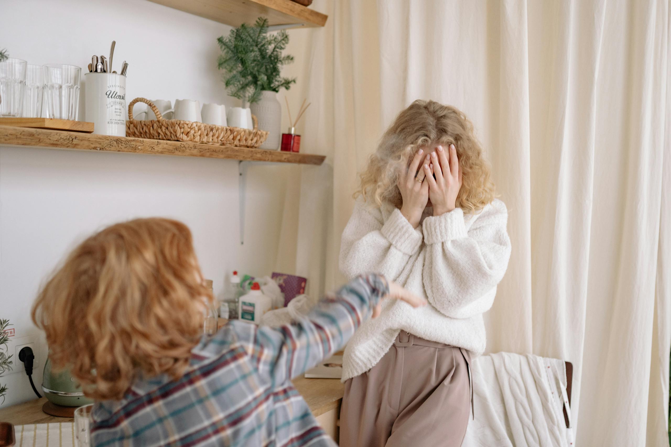 A playful moment between a mother and child at home, filled with joy and laughter.